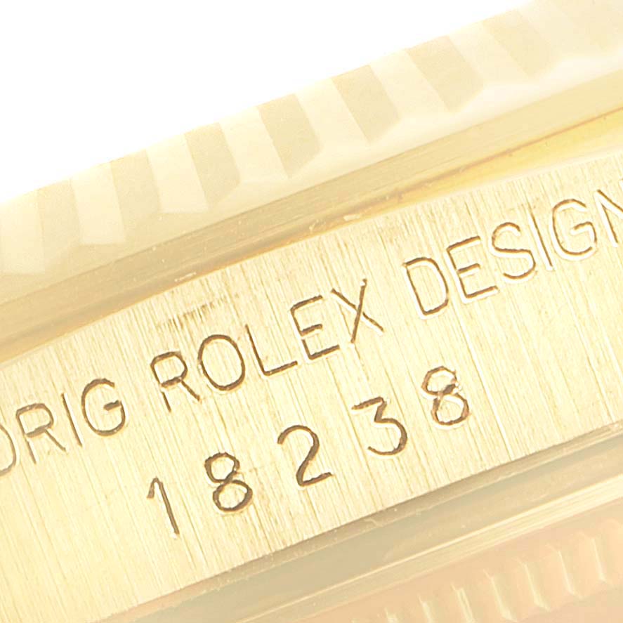 The image shows a close-up of the serial number and part of the bezel of a Rolex President 18238 Men's Yellow Gold Blue Dial 18238 Men's Yellow Gold Blue Dial model watch.