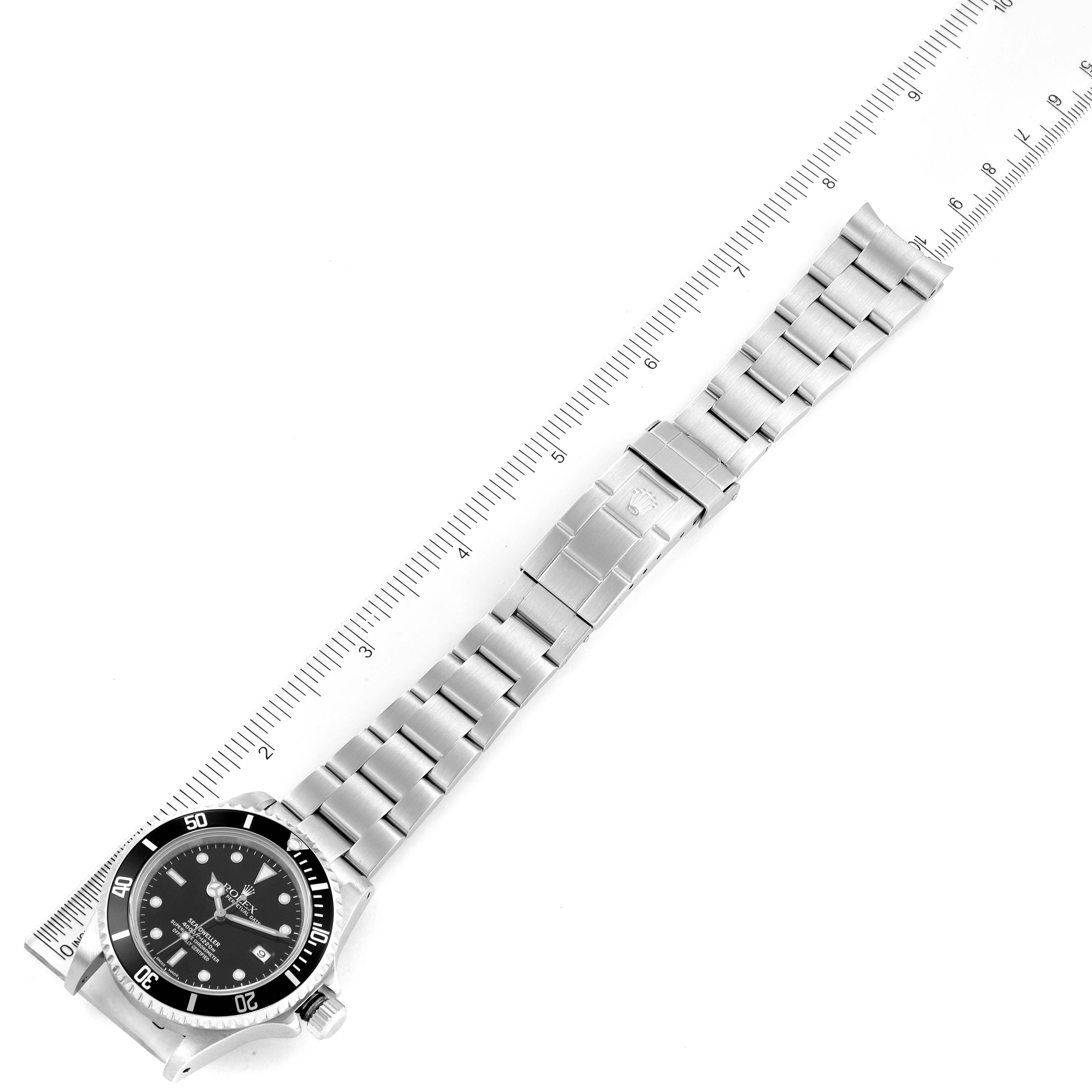 The image shows a top-down view of a Rolex Sea-Dweller 16600 Men
s Stainless Steel Black Dial 16600 Men
s Stainless Steel Black Dial watch, highlighting its dial, bezel, and metal bracelet with a ruler for scale.