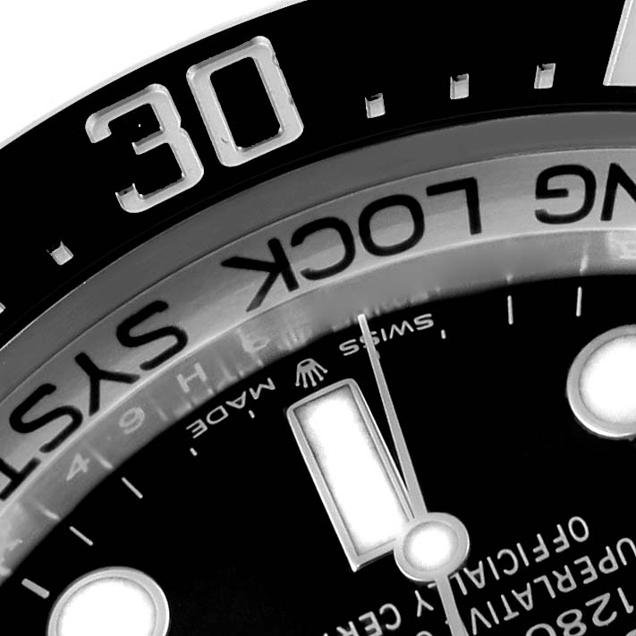 Close-up of the Rolex Sea-Dweller 126660 Men
s Stainless Steel Blue Dial 126660 Men
s Stainless Steel Blue Dial watch, focusing on parts of the bezel, minute markers, and text on the dial.