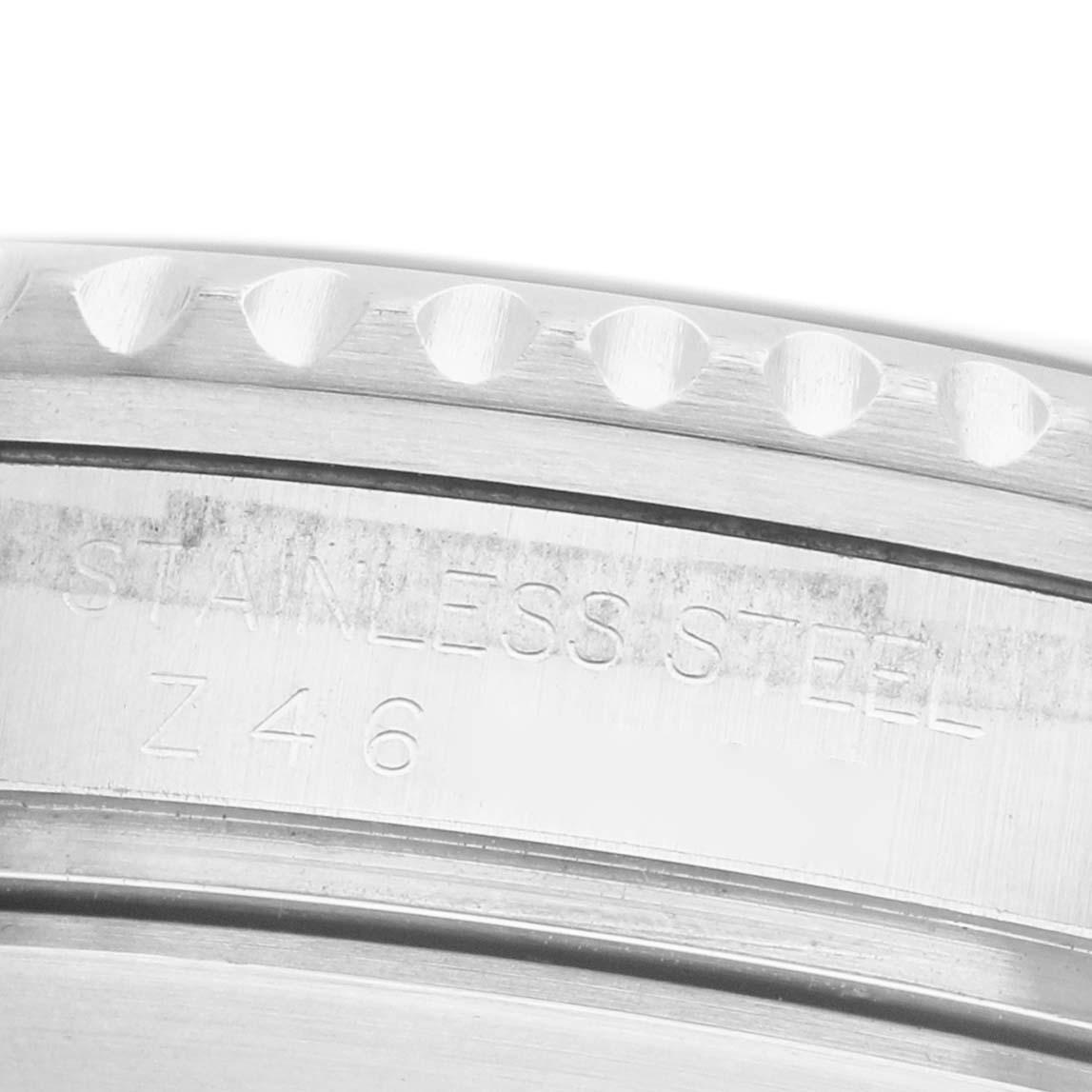 The image shows a close-up angle of the stainless steel case and bezel edge of a Rolex Submariner 16610 Men's Stainless Steel Black Dial watch.