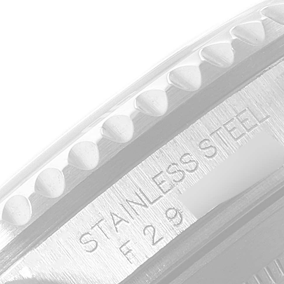 This image shows a close-up of the bezel and engraved stainless steel label of a Rolex Submariner 16610LV Men's Stainless Steel Black Dial 16610LV Men's Stainless Steel Black Dial watch.