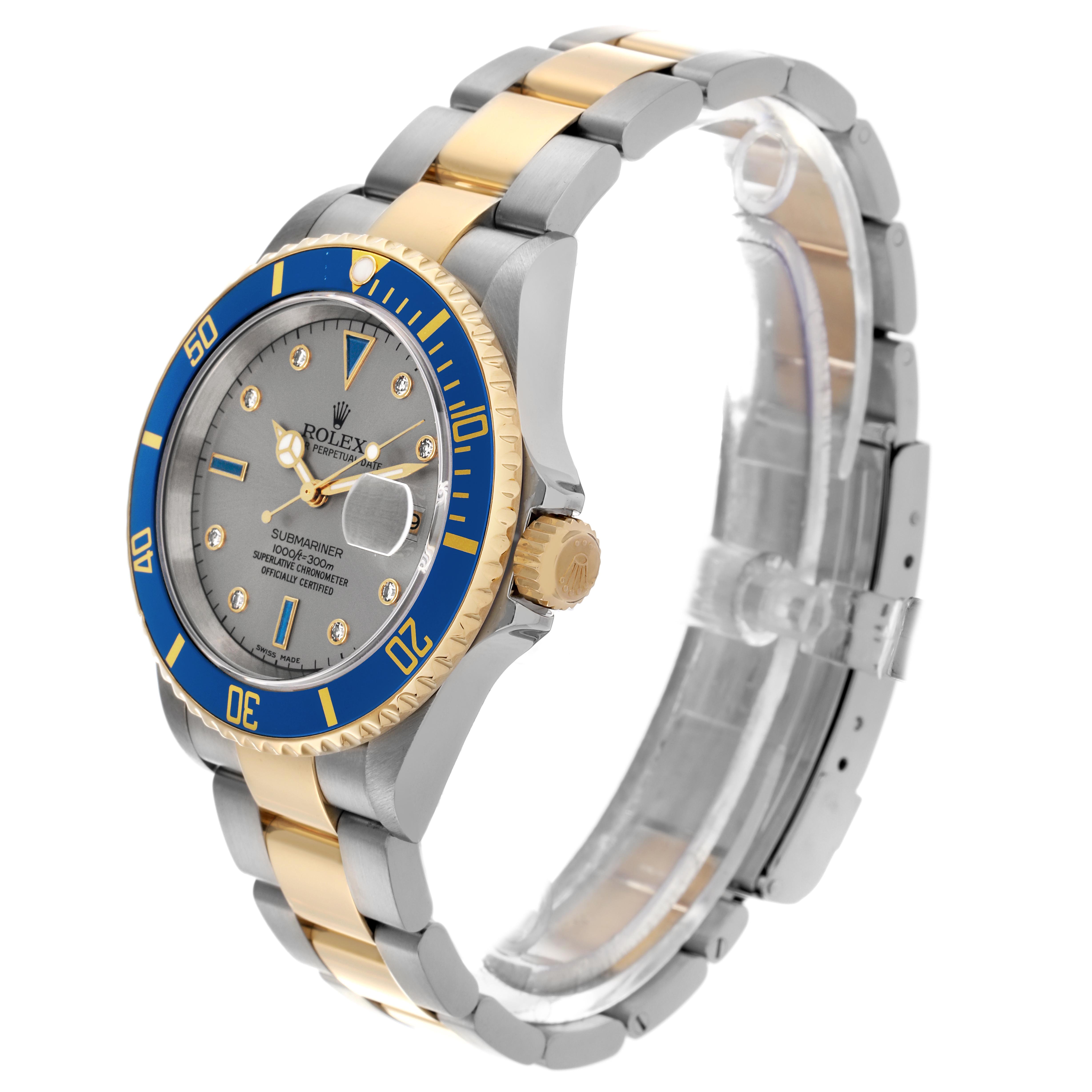 The Rolex Submariner 16613 Men's Steel and Gold (two tone) Silver Dial 16613 Men's Steel and Gold (two tone) Silver Dial watch is shown at a three-quarter angle, highlighting its blue bezel, crown, and two-tone bracelet.