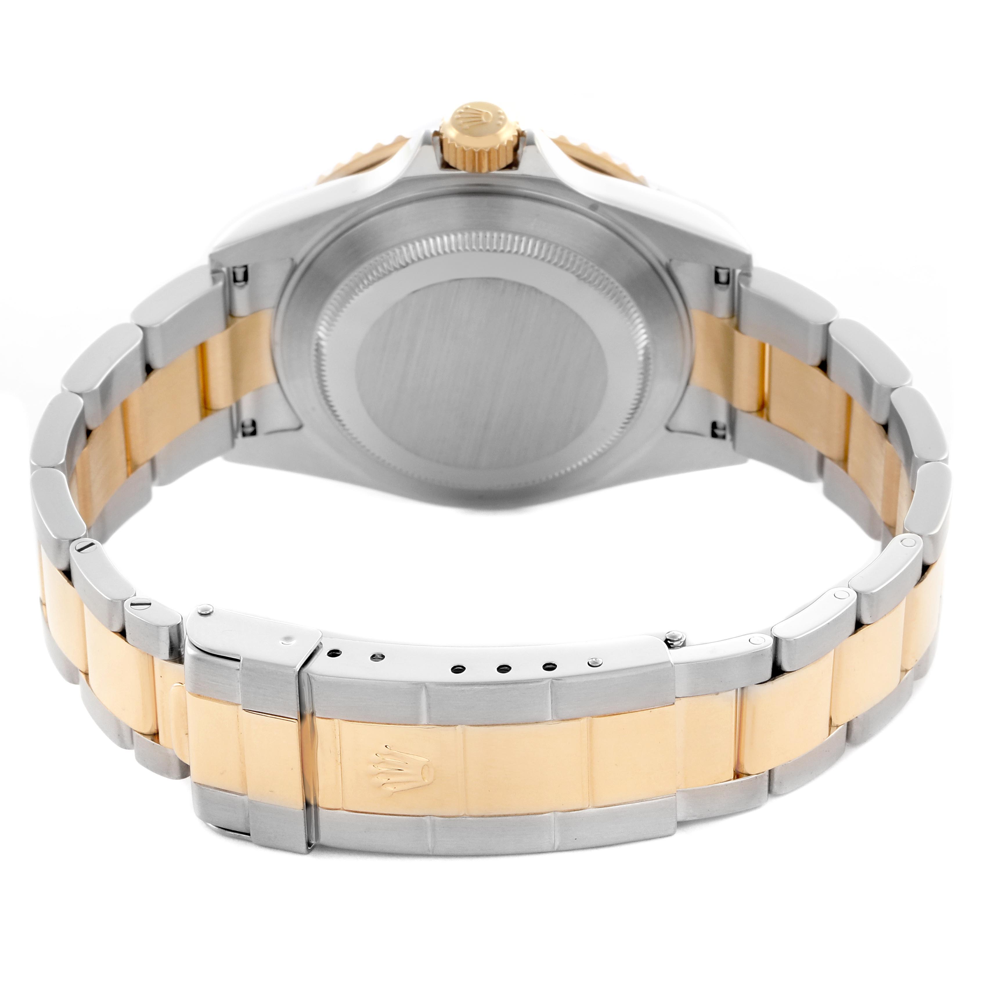 The Rolex Submariner 16613 Men's Steel and Gold (two tone) Silver Dial 16613 Men's Steel and Gold (two tone) Silver Dial watch is shown from the back, highlighting the case back and two-tone bracelet with a visible clasp.