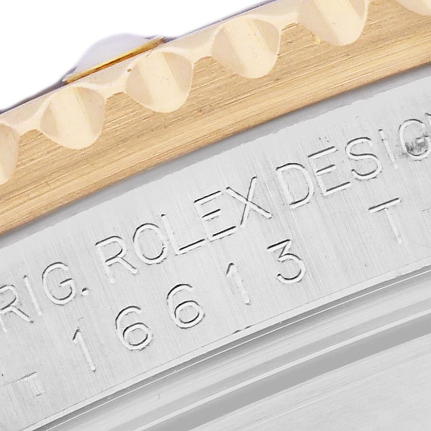 The image shows a close-up of the bezel and case edge of a Rolex Submariner 16613 Men's Steel and Gold (two tone) Silver Dial 16613 Men's Steel and Gold (two tone) Silver Dial, highlighting the model number engraving.