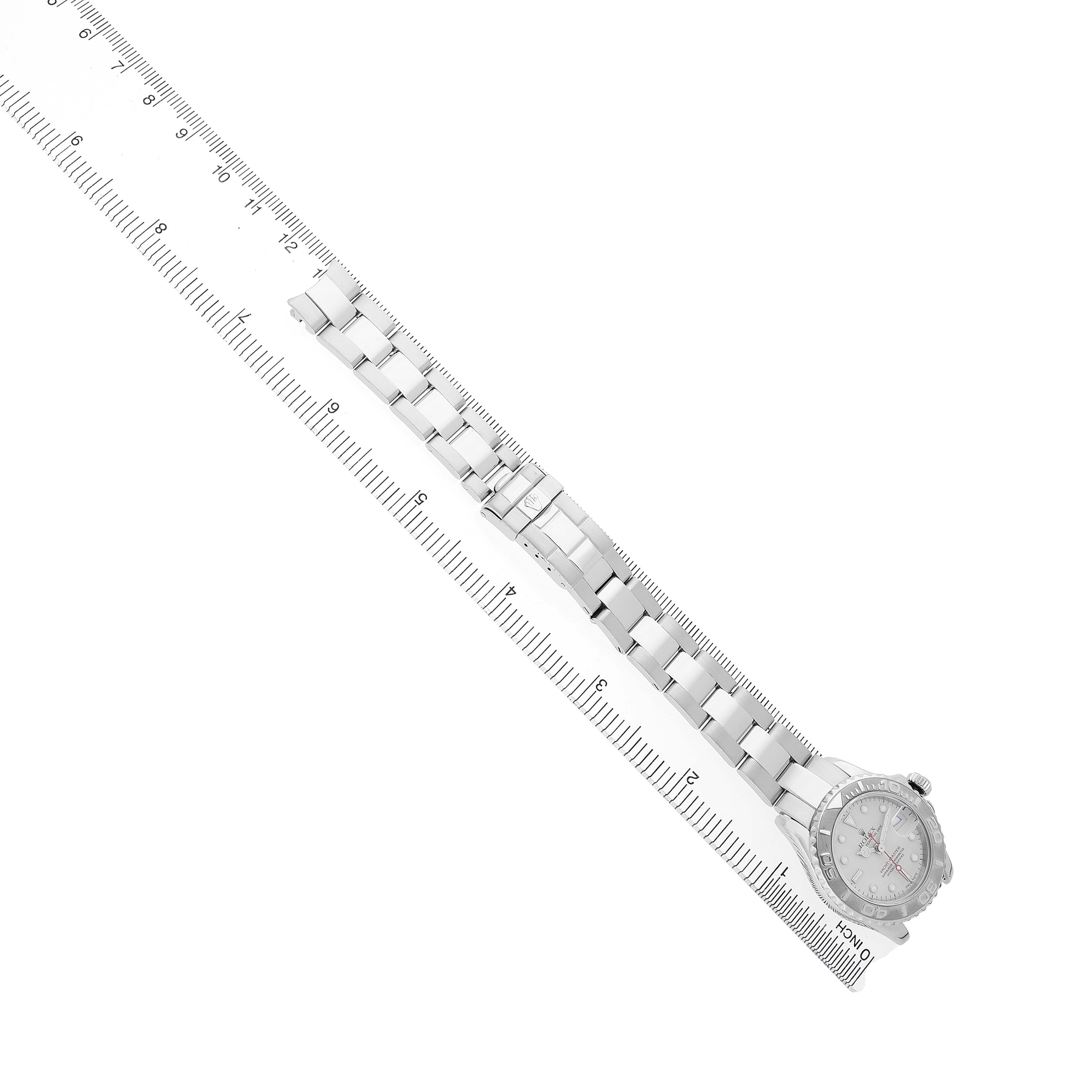The Rolex Yacht-Master 169622 Women's Stainless Steel Silver Dial watch is displayed from a top angle, showing its full bracelet and face alongside a ruler for scale.