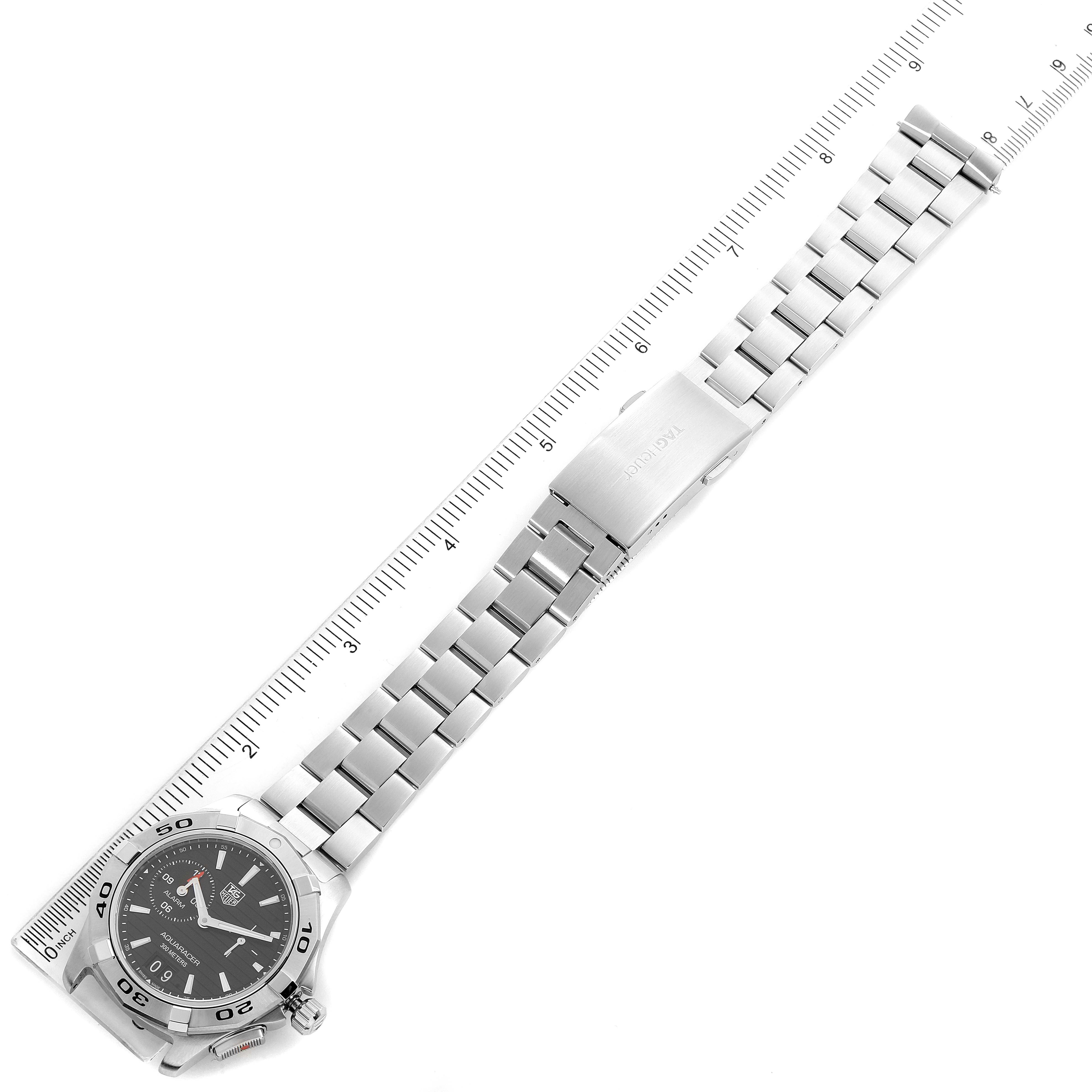 The Tag Heuer Aquaracer WAP111Z.BA0831 Men
s Stainless Steel Black Dial WAP111Z.BA0831 Men
s Stainless Steel Black Dial watch is shown from an overhead angle, displaying the face, bezel, and full stainless steel bracelet alongside a ruler.