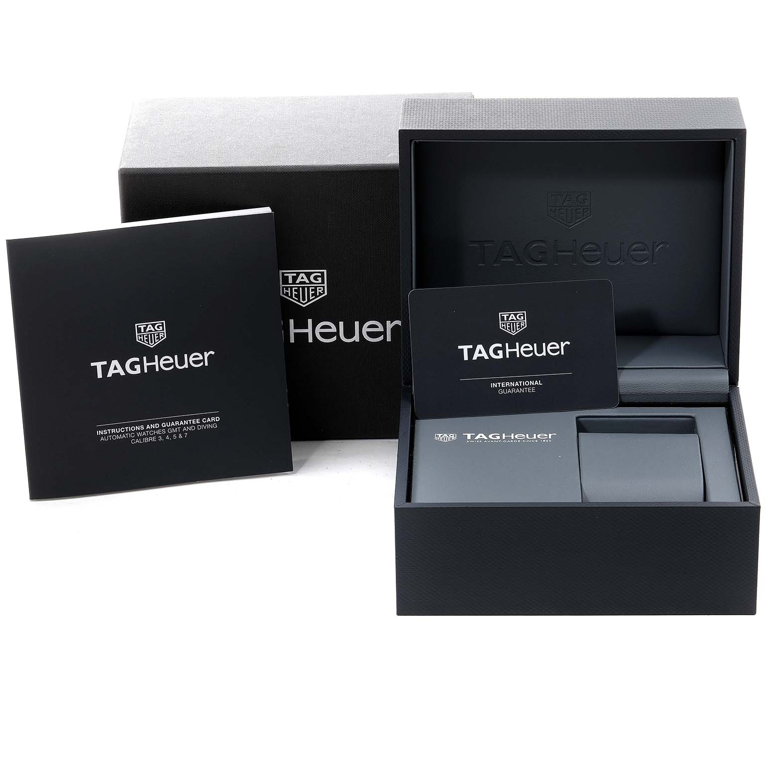 The image shows the packaging, international guarantee card, and instructions booklet for a Tag Heuer Link WBC2112.BA0603 Men's Stainless Steel Blue Dial WBC2112.BA0603 Men's Stainless Steel Blue Dial model watch.