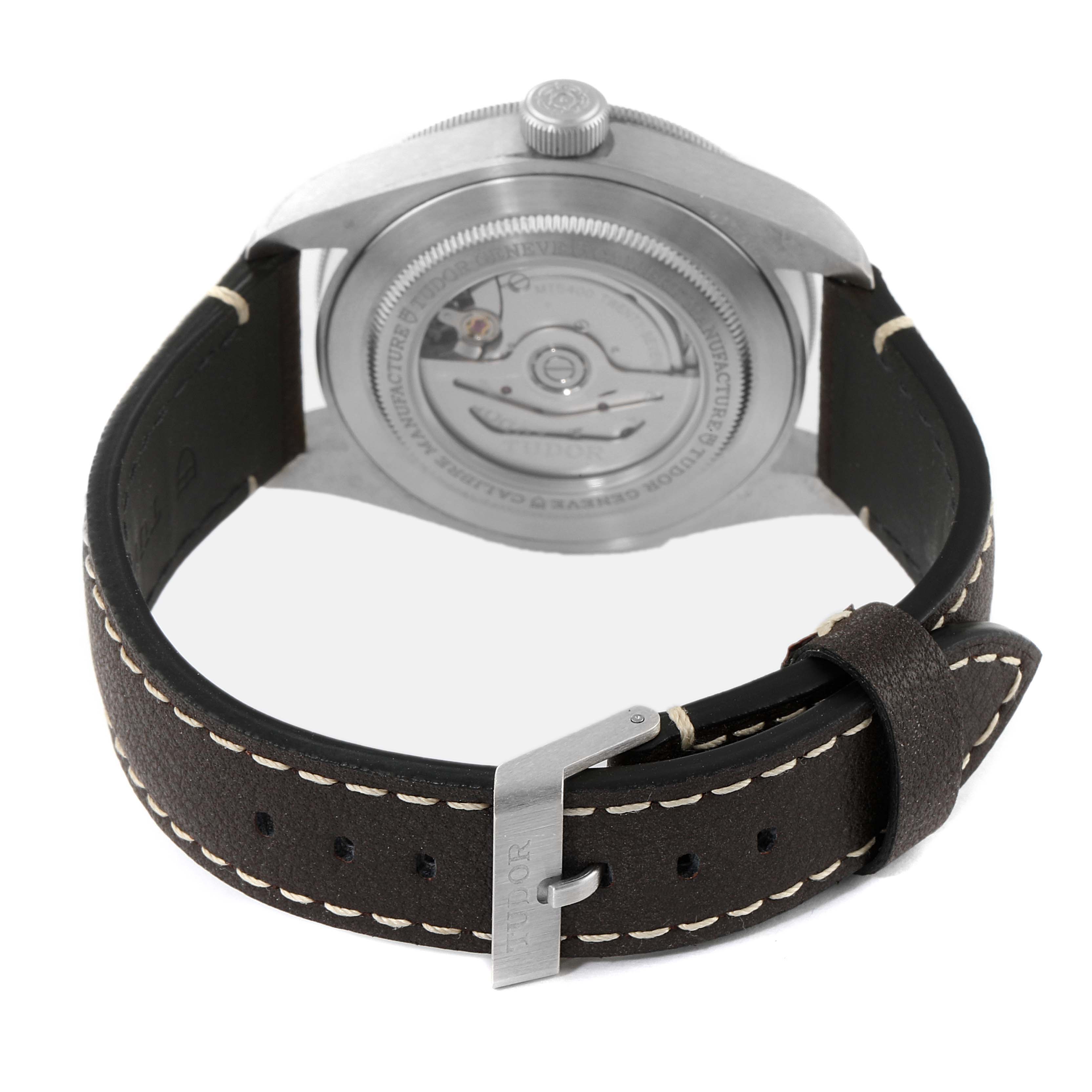 The image shows the back view of a Tudor Heritage Black Bay 79010SG Men's Stainless Steel Grey Dial 79010SG Men's Stainless Steel Grey Dial watch, highlighting the case back and the buckle of the leather strap.