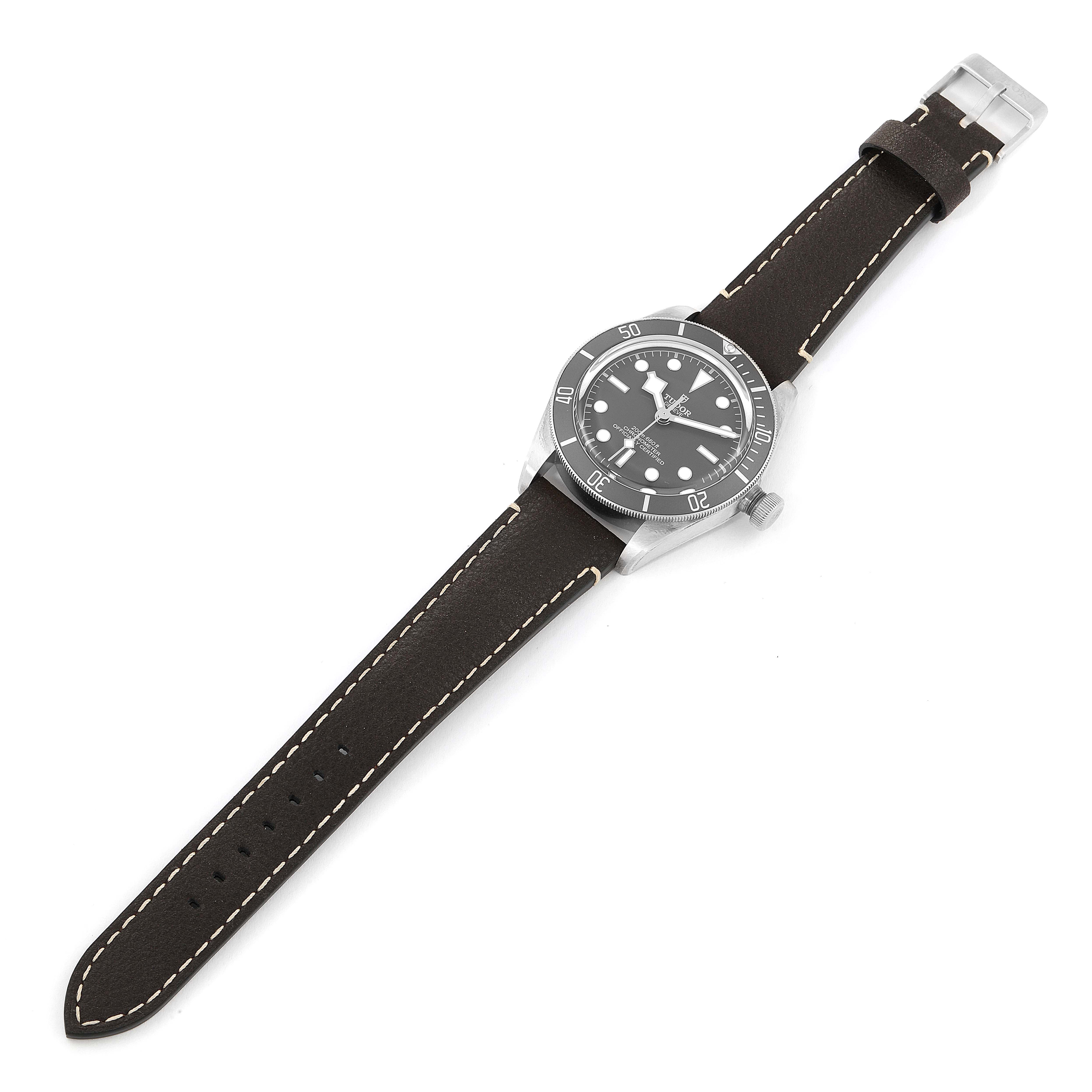 The image shows a Tudor Heritage Black Bay 79010SG Men's Stainless Steel Grey Dial 79010SG Men's Stainless Steel Grey Dial watch from an overhead angle, displaying its dial, bezel, case, and leather strap.