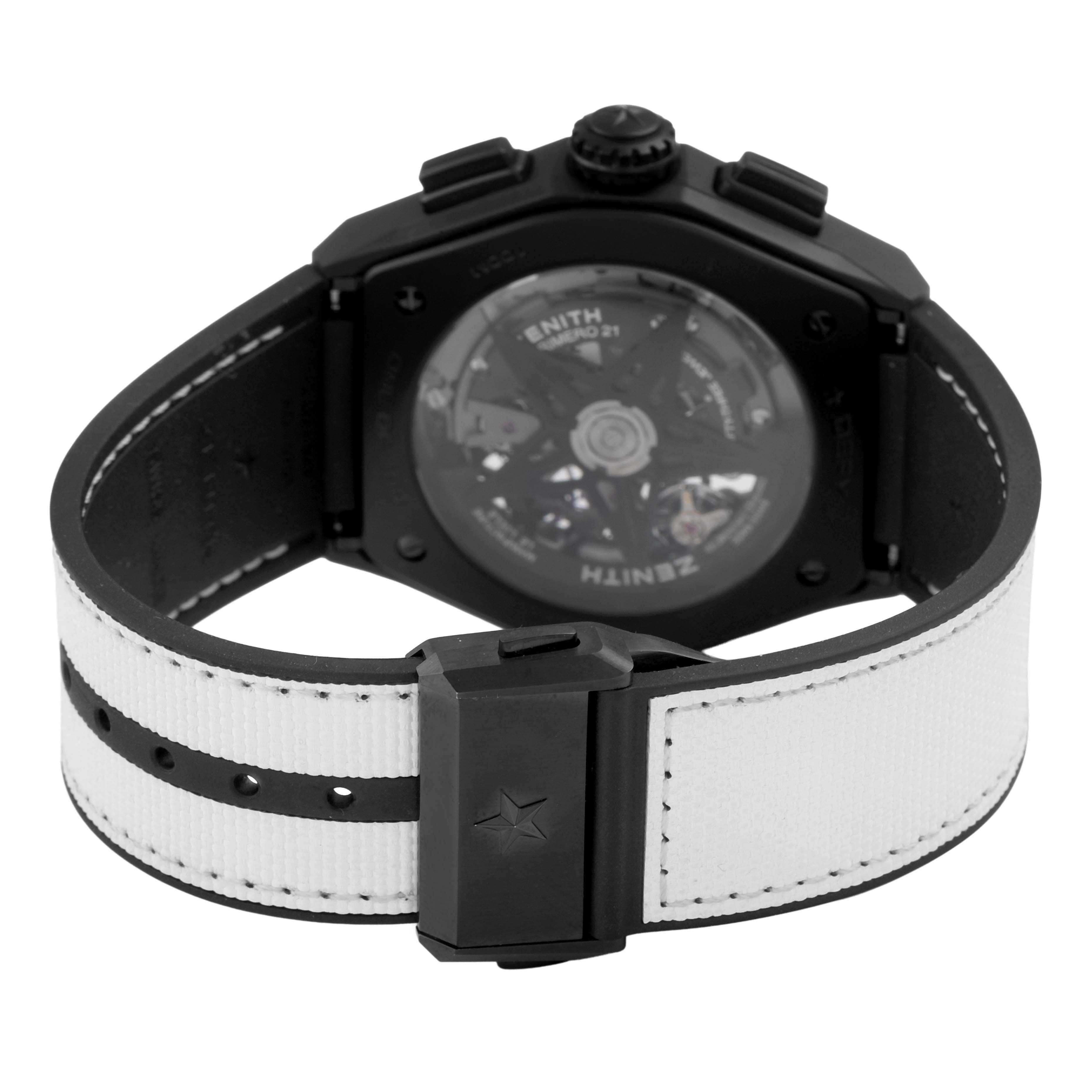 The Zenith Defy 49.9007.9004 Men's Ceramic Black Dial watch is shown from the back, highlighting its transparent caseback and black-and-white strap.