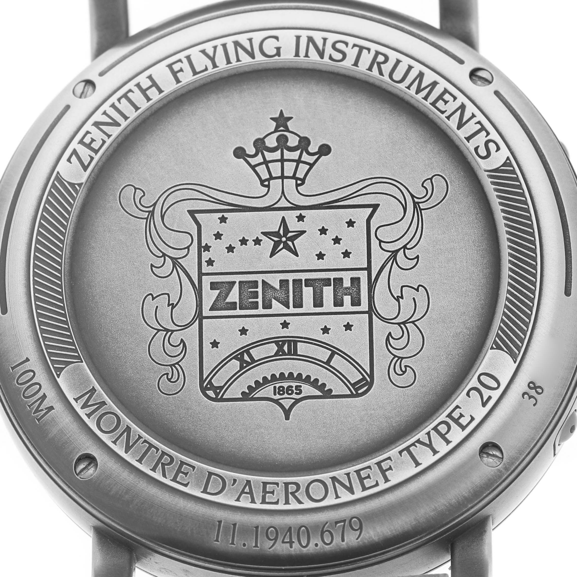 The image shows the case back of the Zenith Pilot 11.1940.679 Men's Stainless Steel Grey Dial watch, featuring engravings and brand markings.