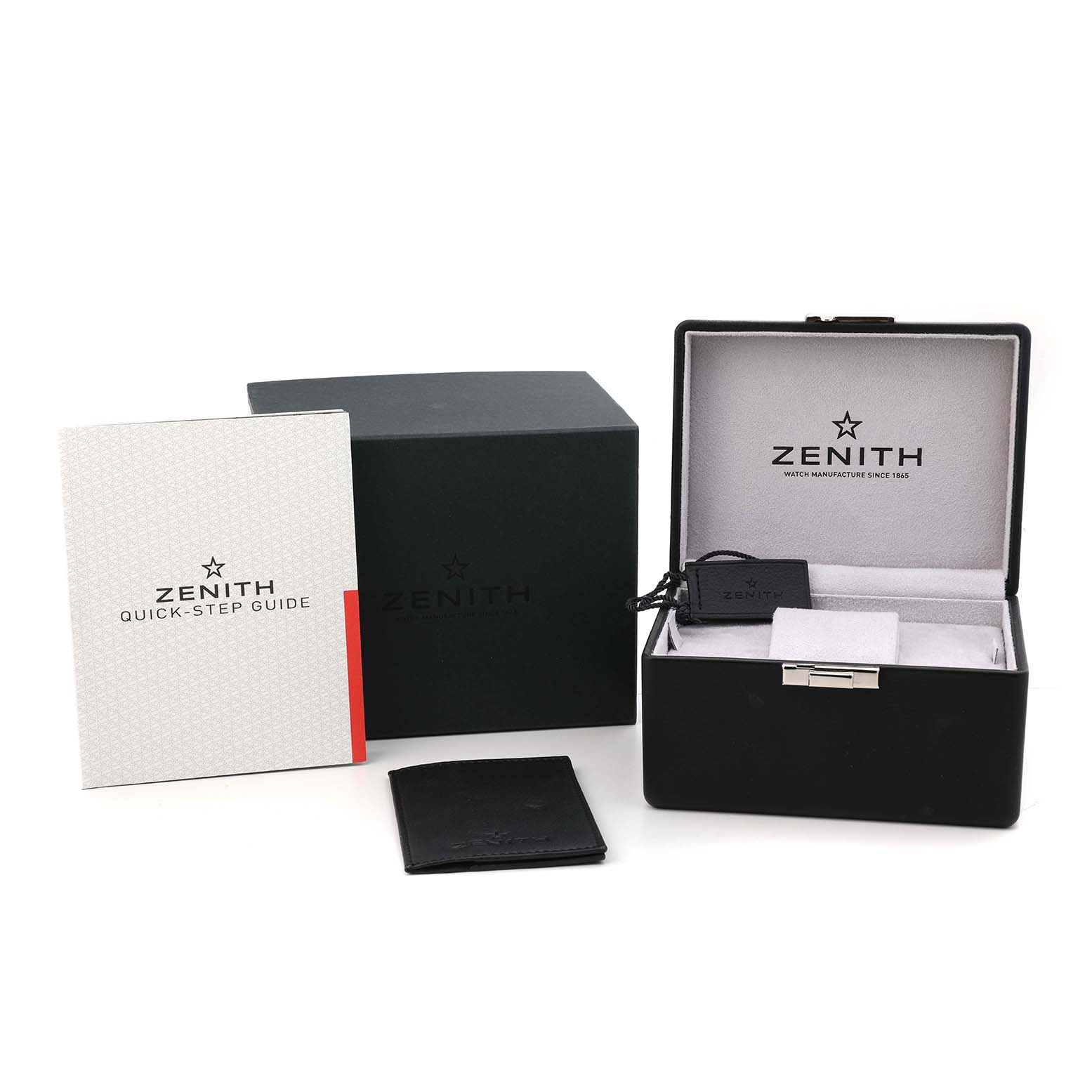 The image shows a Zenith Pilot 11.1940.679 Men's Stainless Steel Grey Dial model's open black box, a quick-step guide, and related accessories from a front angle.