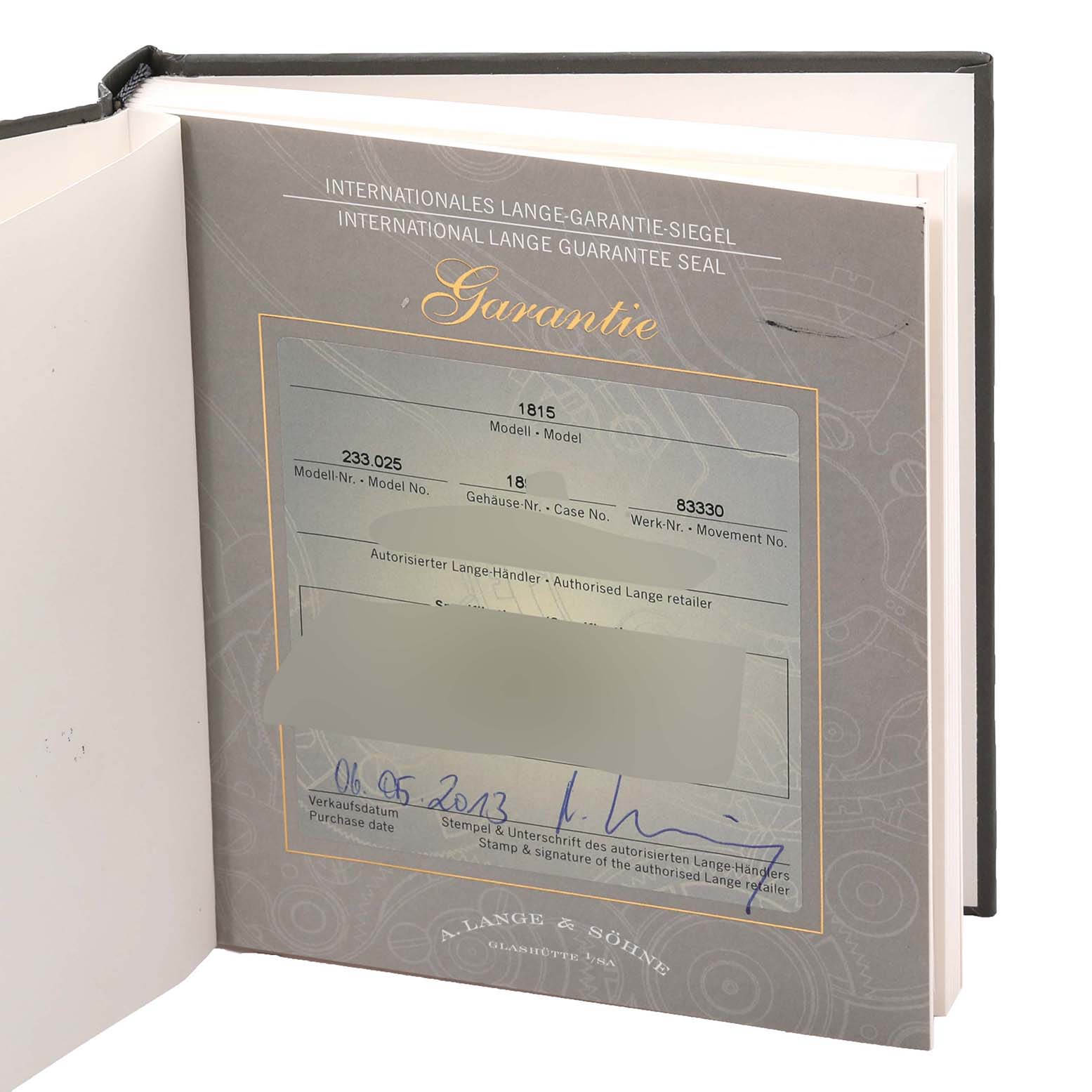 The image shows the certificate of an 1815 model watch by A. Lange & Söhne, opened and partially obscured.