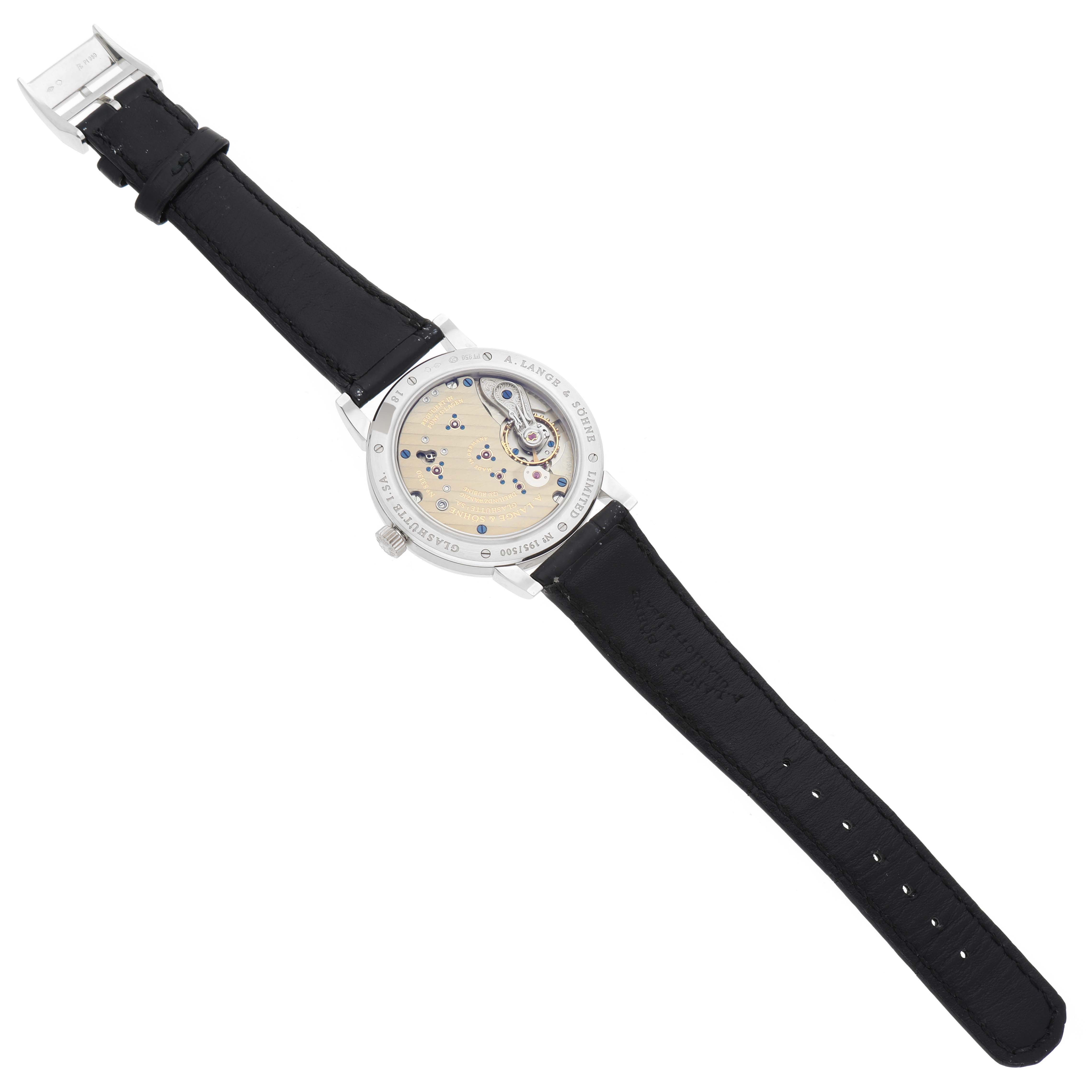 The image shows the back view of the 1815 model by A. Lange & Söhne, revealing its internal mechanism and black leather strap.