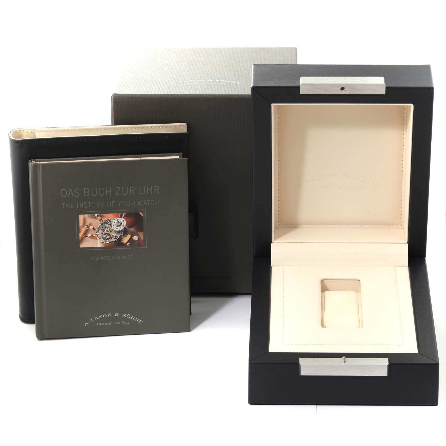 The image shows the packaging, a book, and the presentation box for a Richard Lange model by A. Lange & Söhne.