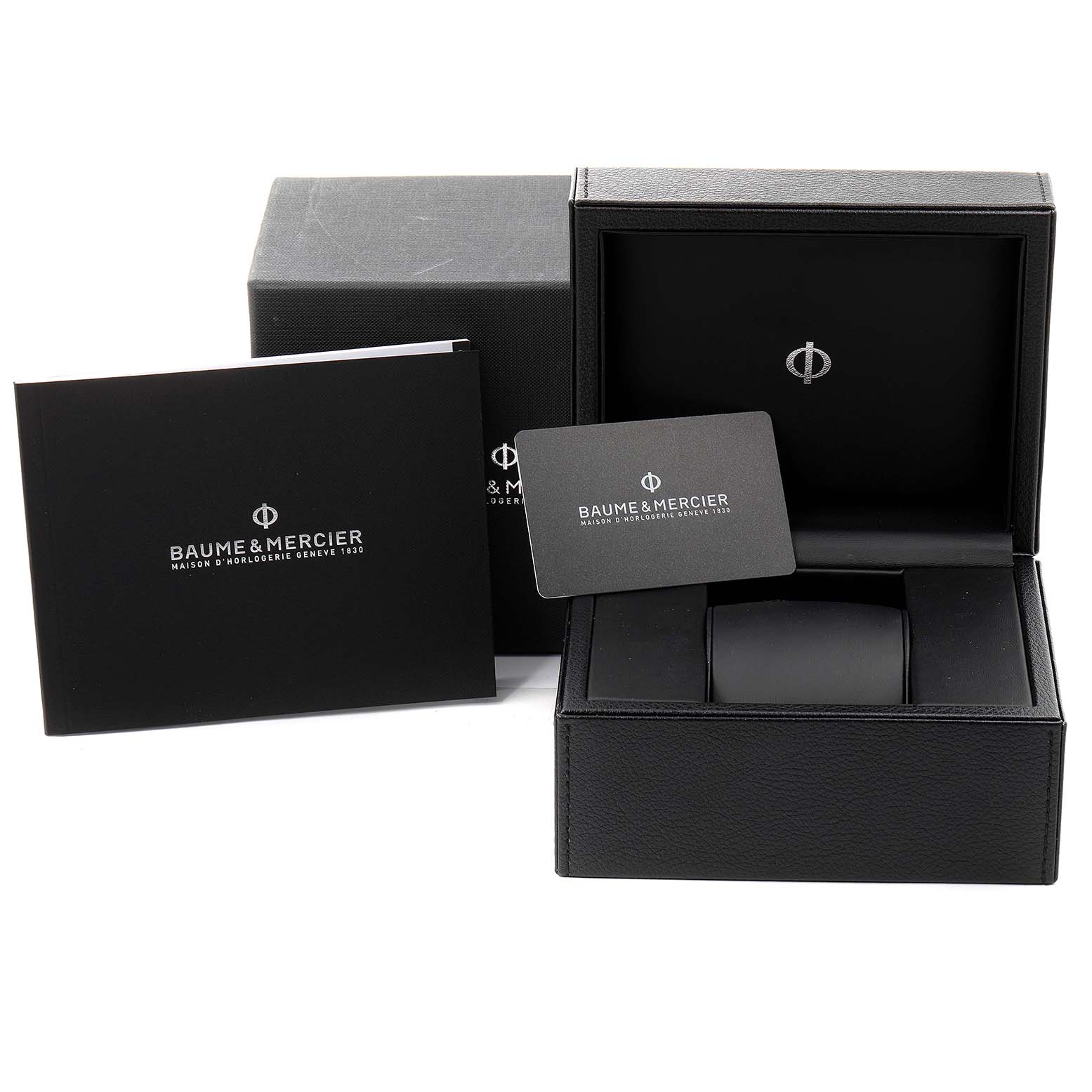 The image shows the packaging, box, booklet, and warranty card for a Baume & Mercier Clifton M0A10467 Men's Stainless Steel Blue Dial M0A10467 Men's Stainless Steel Blue Dial watch.