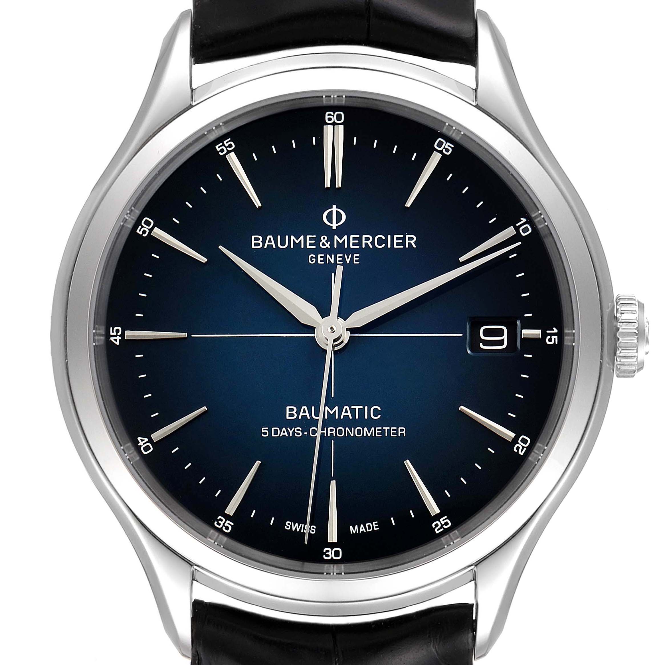 The image shows a front view of a Baume & Mercier Clifton M0A10467 Men's Stainless Steel Blue Dial M0A10467 Men's Stainless Steel Blue Dial Baumatic watch with a blue dial, date display, and black leather strap.
