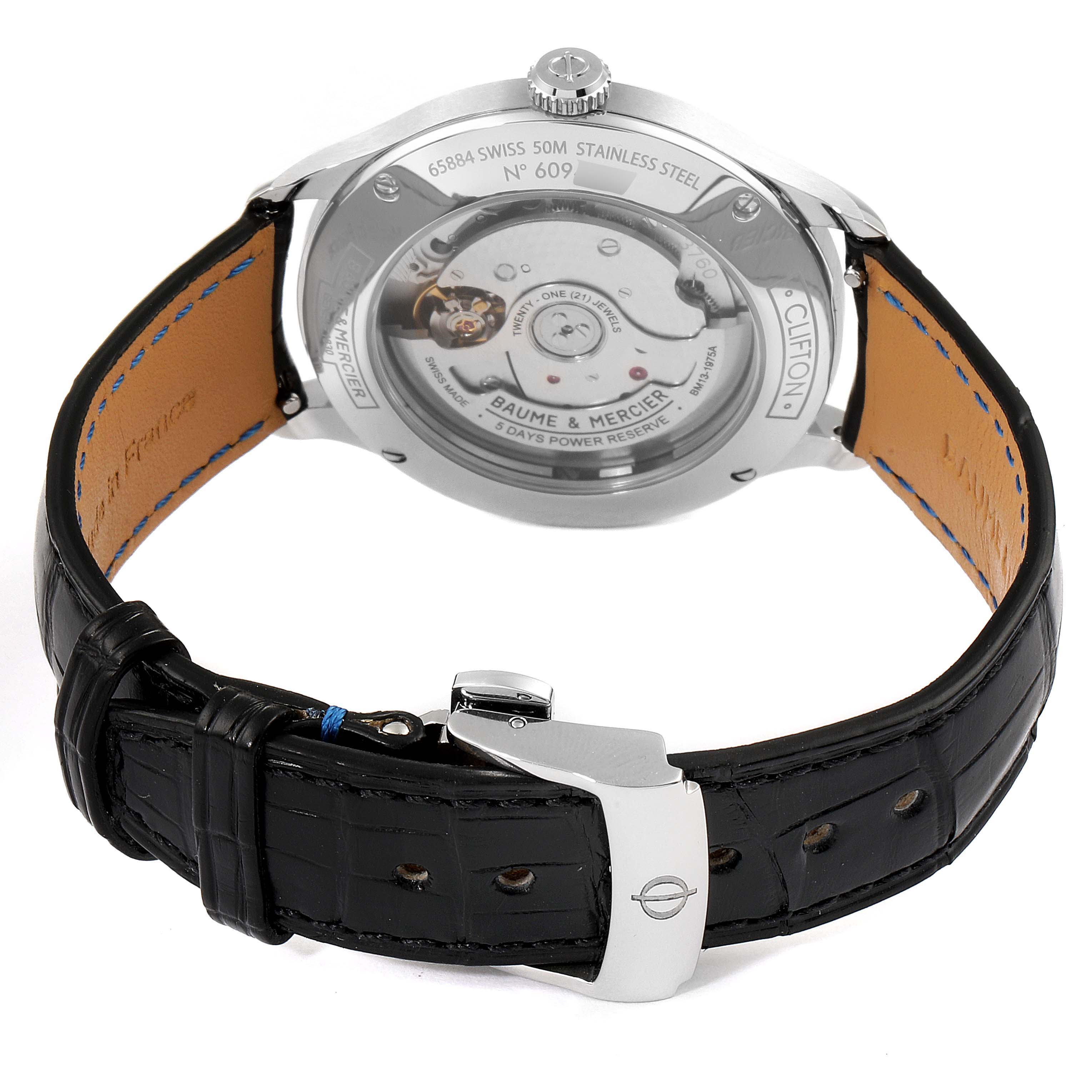 The image shows the back view of the Baume & Mercier Clifton M0A10467 Men's Stainless Steel Blue Dial M0A10467 Men's Stainless Steel Blue Dial watch, highlighting its movement and leather strap with a buckle.