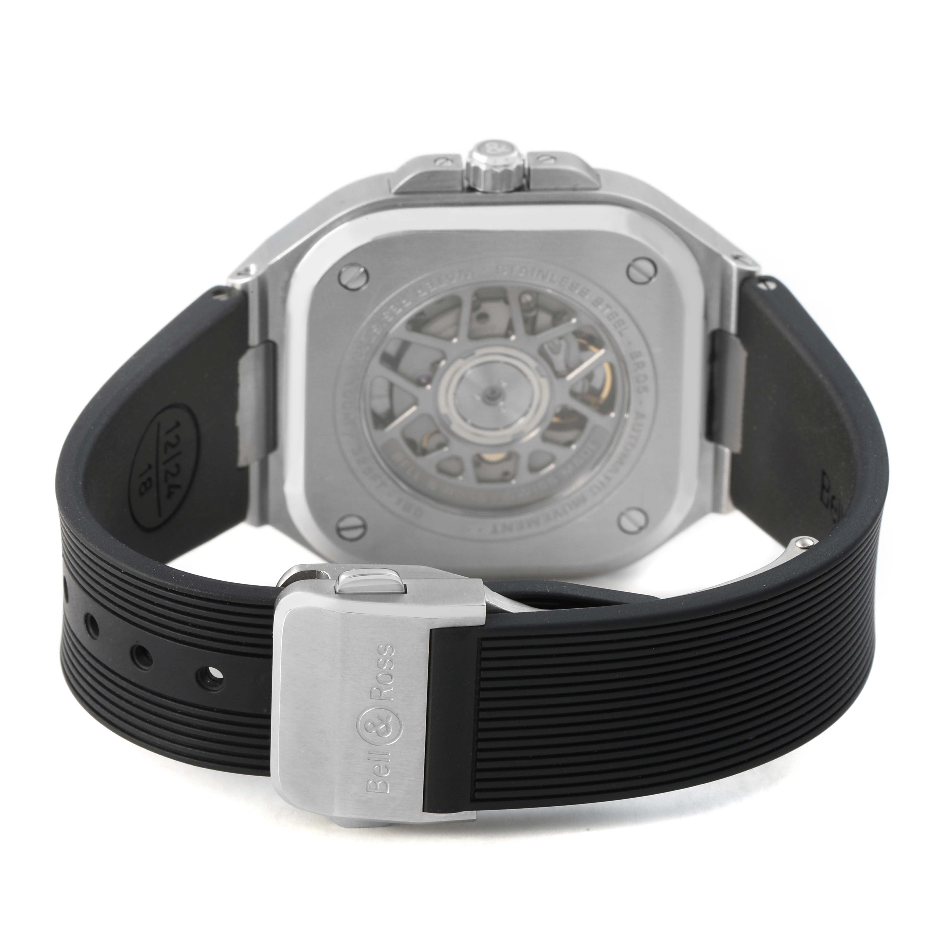 The image shows the back of the Bell & Ross Urban BR05G-BL-ST/SRB Men's Stainless Steel Black Dial model, featuring its movement through a transparent case back and a black strap with a clasp.