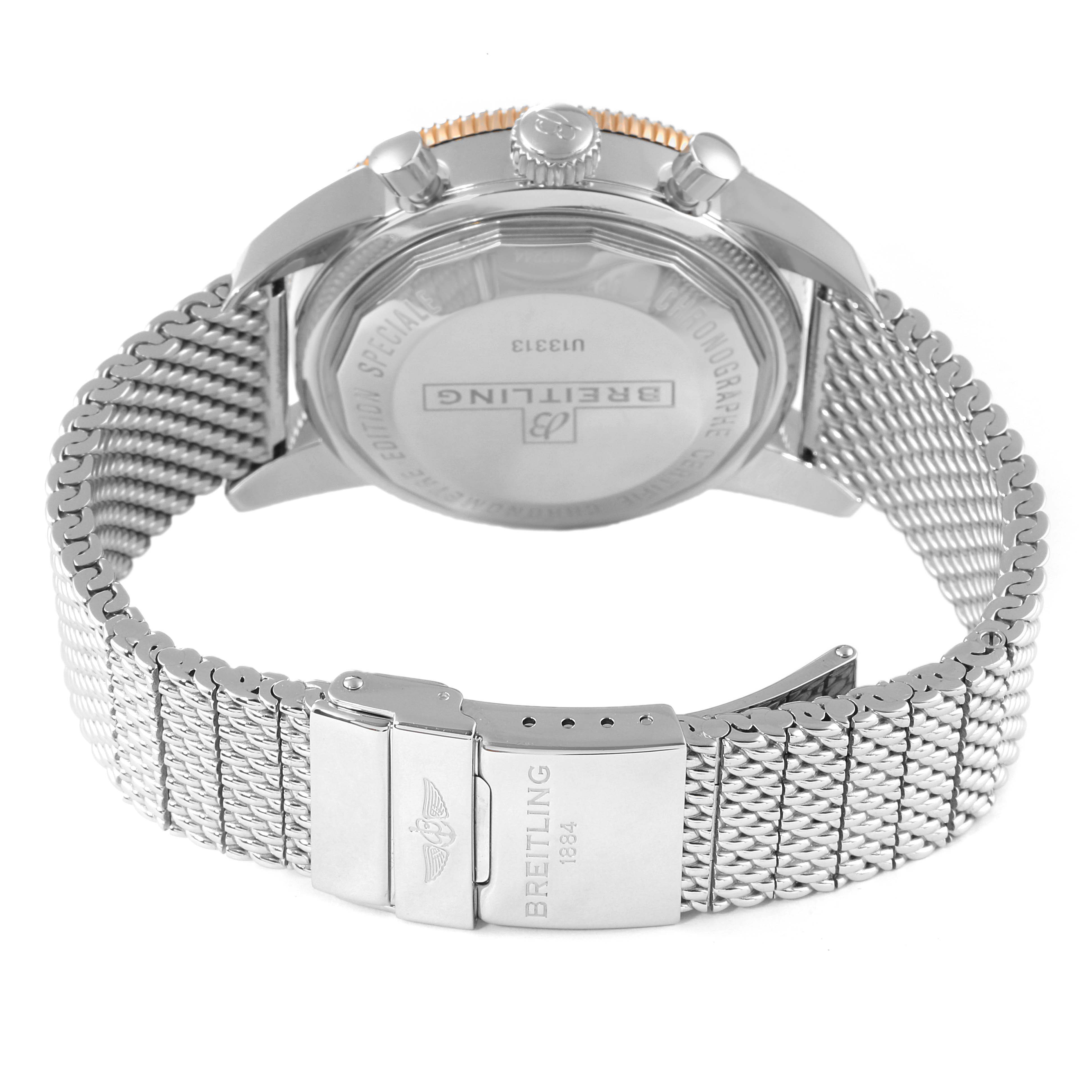 This Breitling Superocean U13313121B1A1 Men's Steel and Gold (two tone) Black Dial U13313121B1A1 Men's Steel and Gold (two tone) Black Dial watch is shown from the rear, highlighting the case back and metal mesh bracelet with clasp.