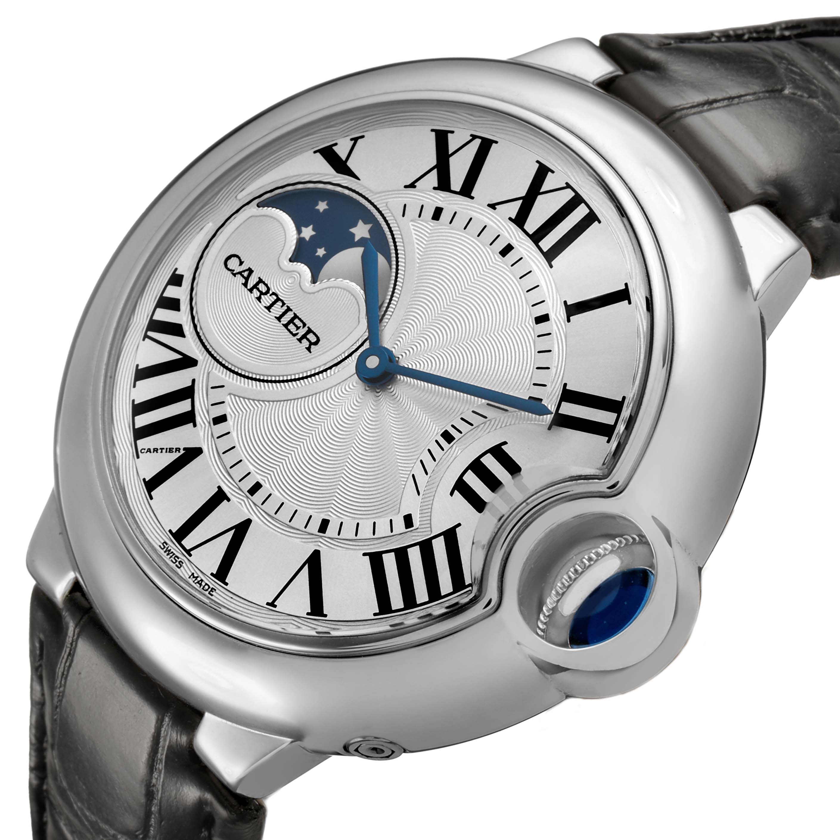 The Cartier Ballon Bleu WSBB0020 Men's Stainless Steel Silver Dial watch is shown at an angle highlighting its dial, moon phase, Roman numerals, and distinctive crown.