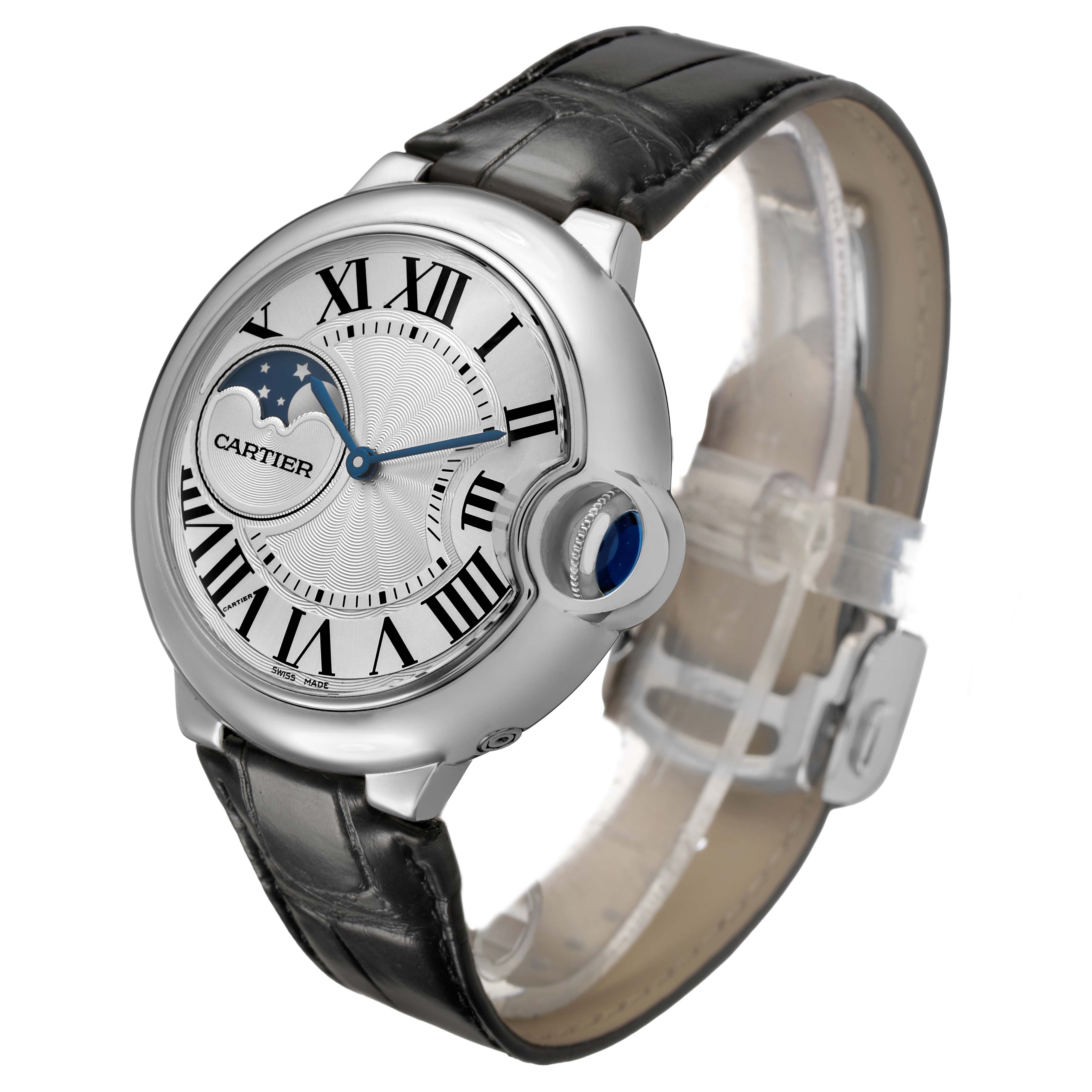 The Cartier Ballon Bleu WSBB0020 Men's Stainless Steel Silver Dial watch is shown at a three-quarter angle, displaying its dial, crown with blue cabochon, and black leather strap.