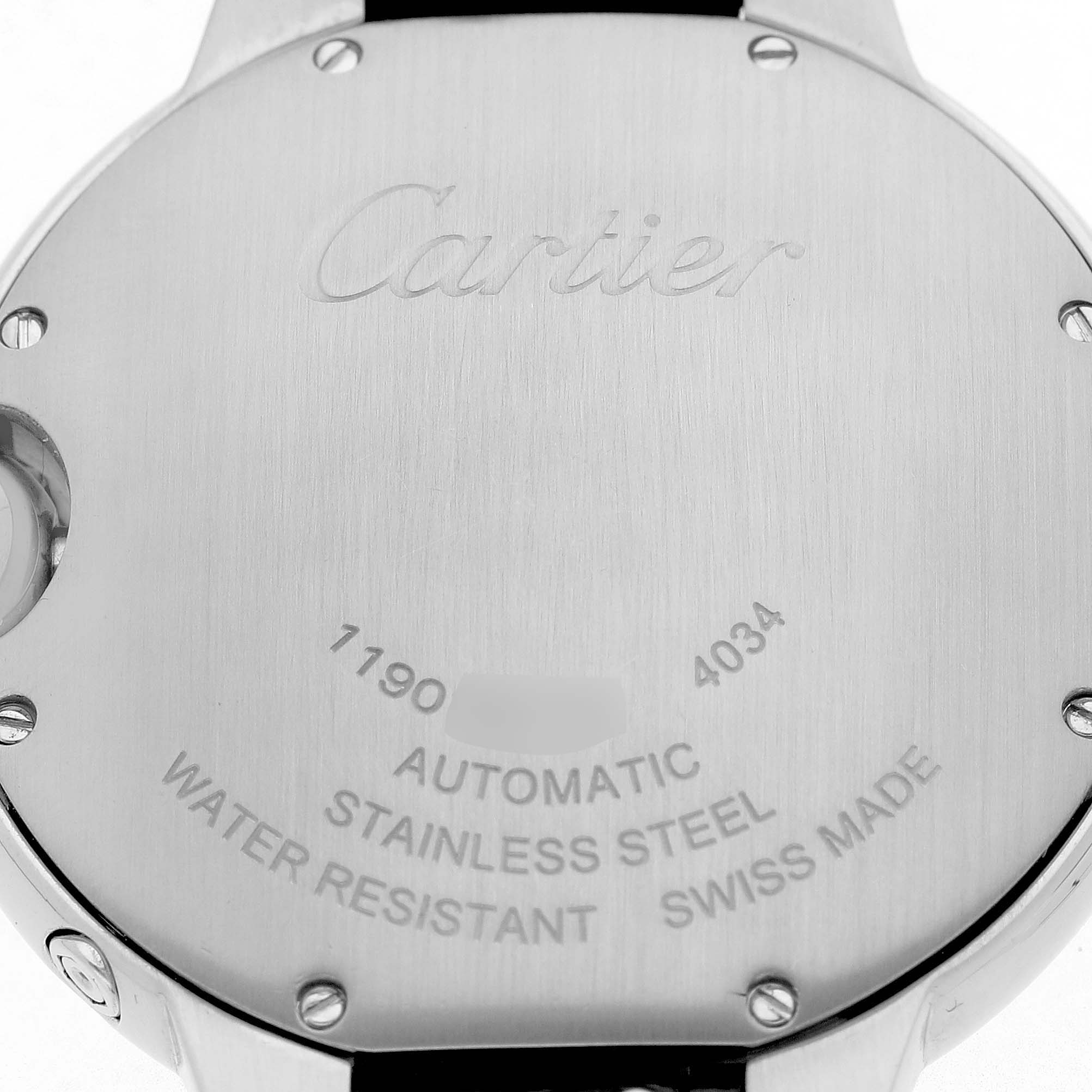 The image shows the back case of a Cartier Ballon Bleu WSBB0020 Men's Stainless Steel Silver Dial watch, highlighting its inscriptions and material.