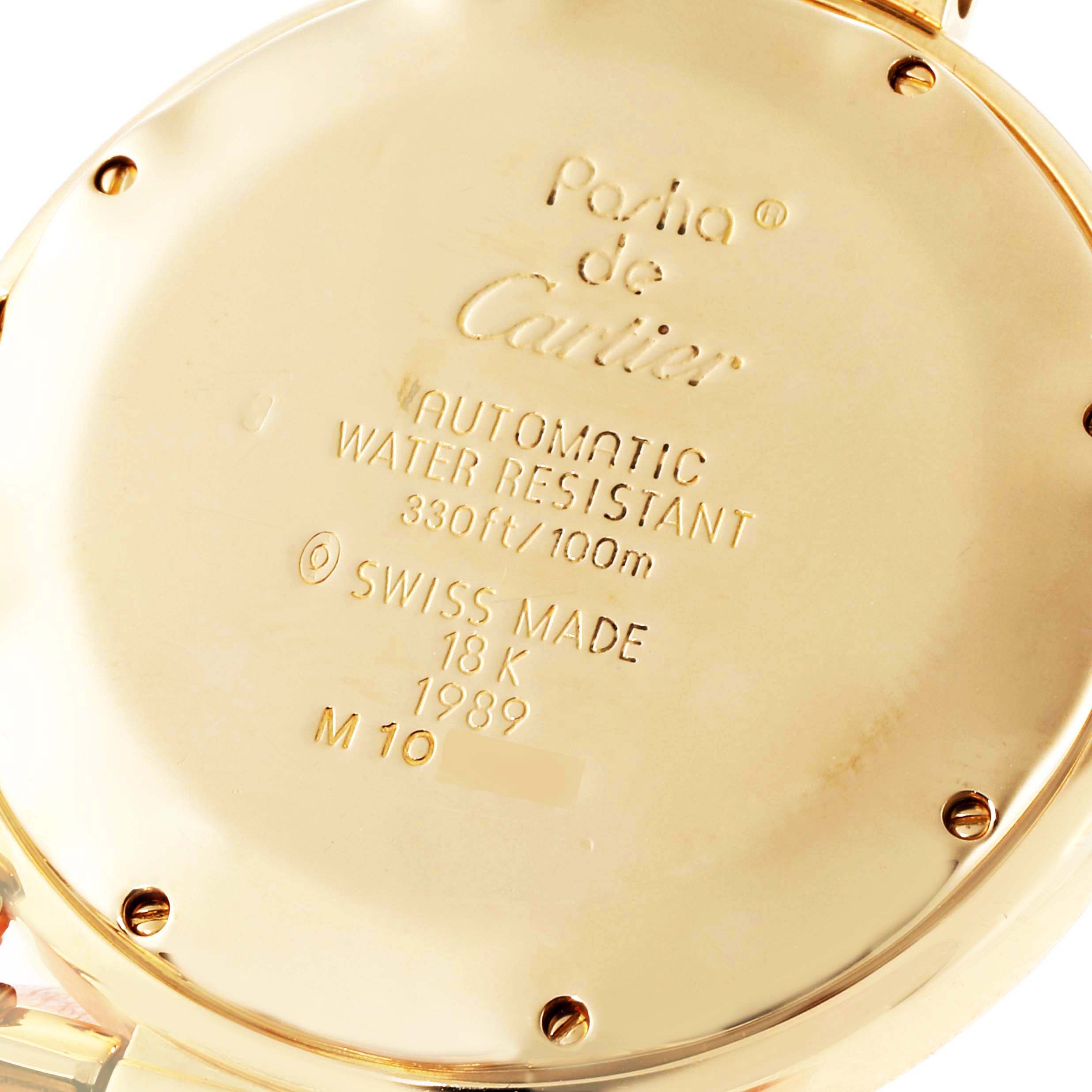 This image shows the back case of a Cartier Pasha 1989 Men's Yellow Gold Silver Dial 1989 Men's Yellow Gold Silver Dial watch, highlighting its engravings and water resistance information.