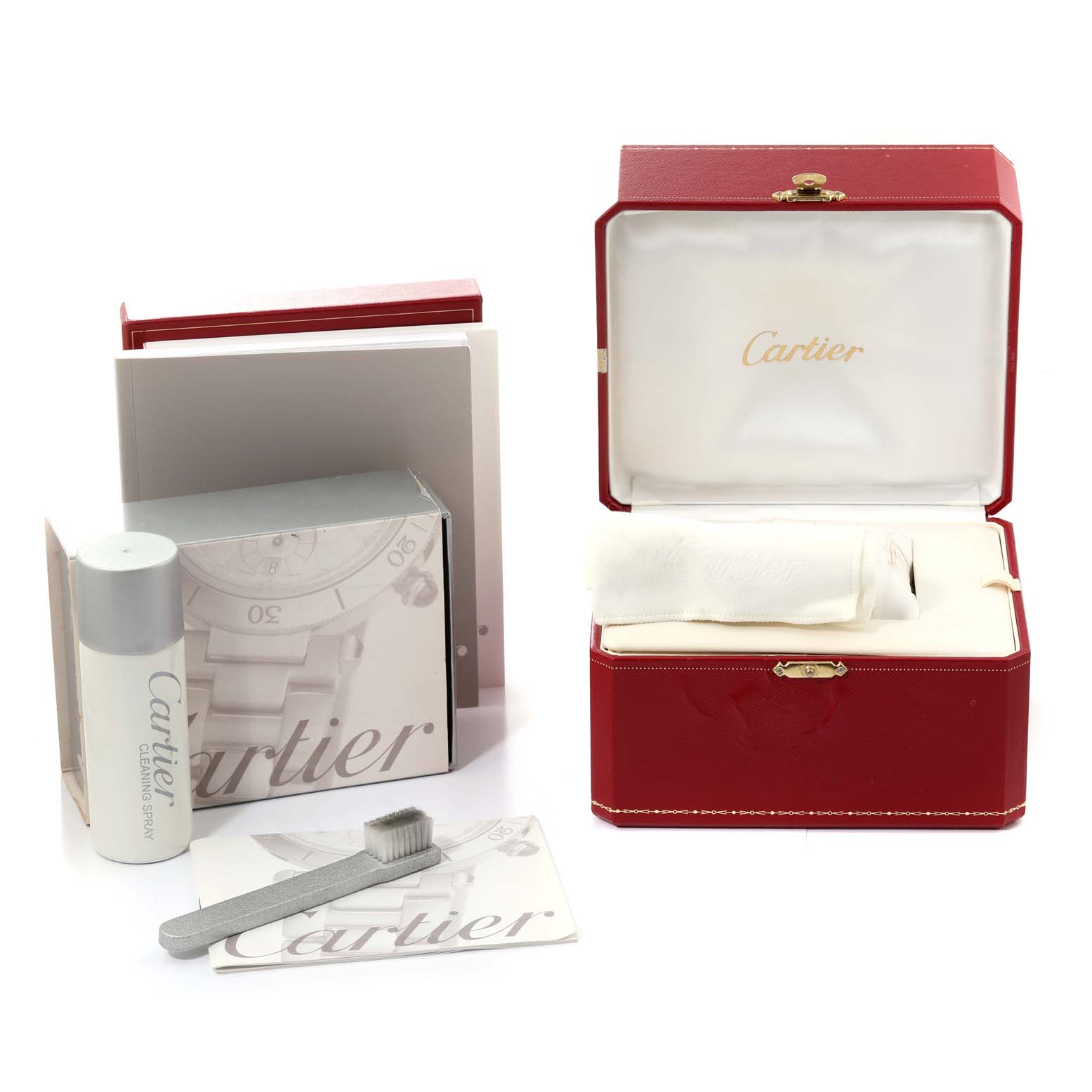 The image shows a red Cartier box, cleaning brush, cleaning spray, manuals, and accessories for the Roadster model by Cartier.