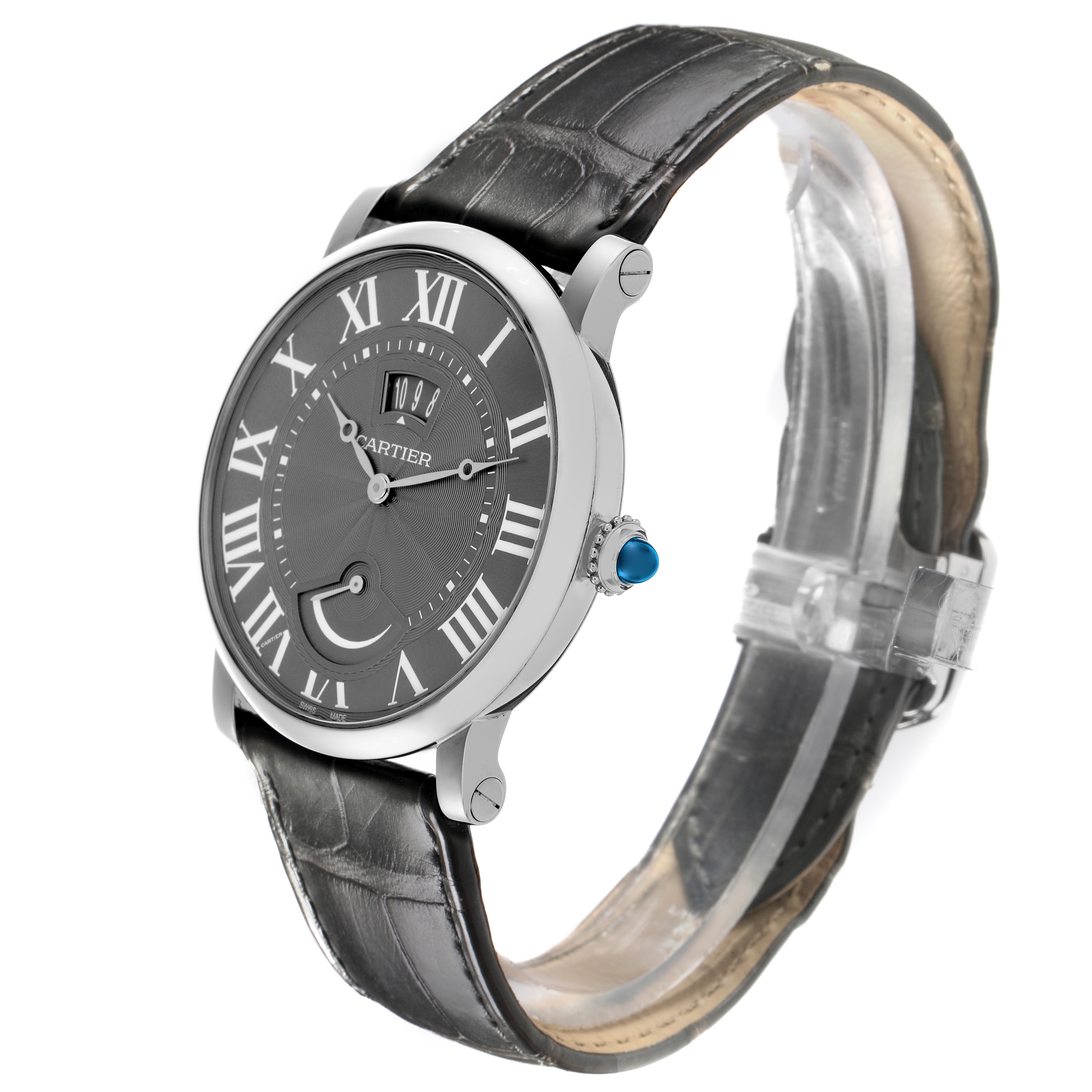The Cartier Rotonde W1556253 Men's White Gold Grey Dial W1556253 Men's White Gold Grey Dial watch is shown at a three-quarter angle, displaying the face, bezel, crown with a blue gemstone, and black strap.