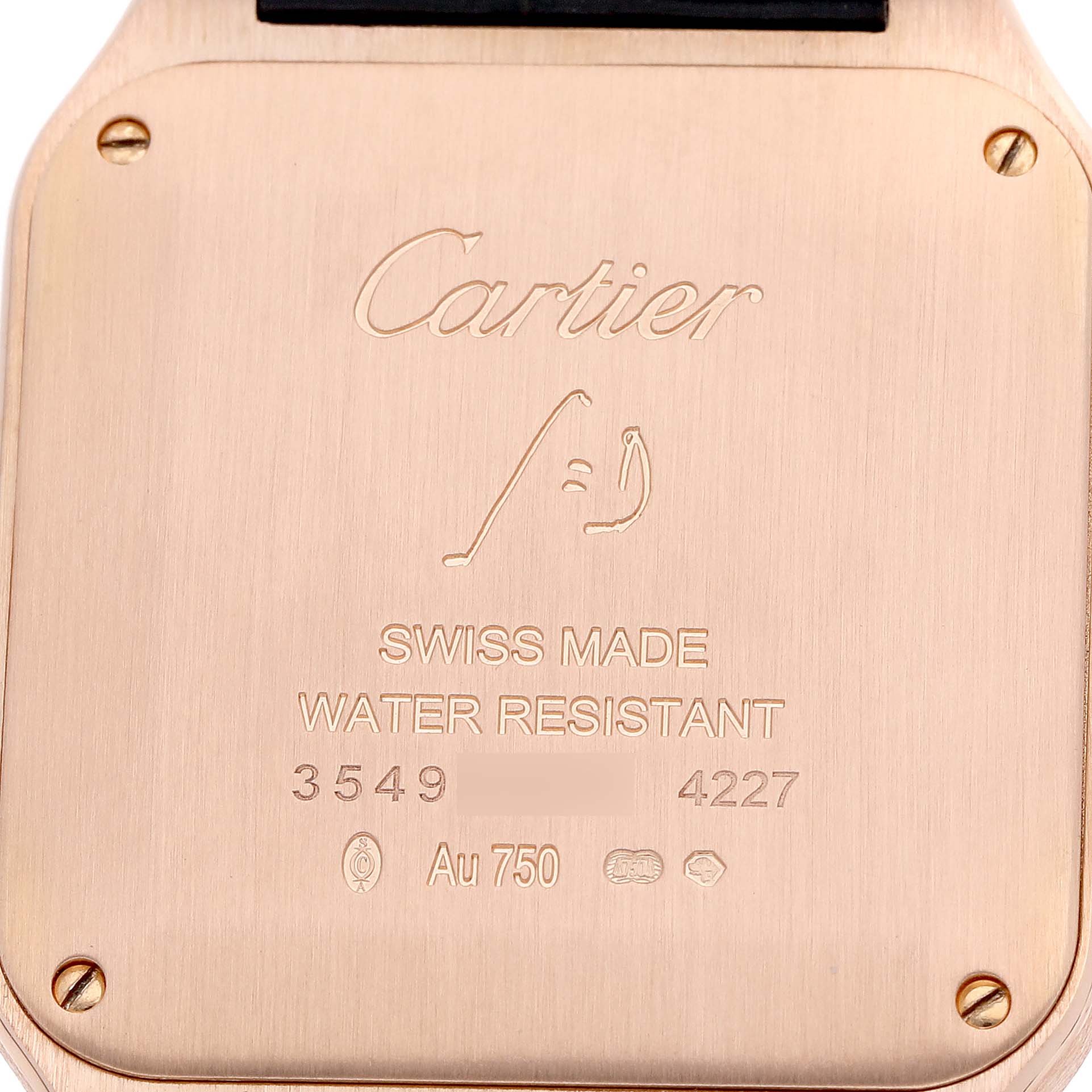 The image shows the back plate of the Cartier Santos Dumont WGSA0021 Men's Rose Gold Silver Dial watch, displaying branding and specifications.