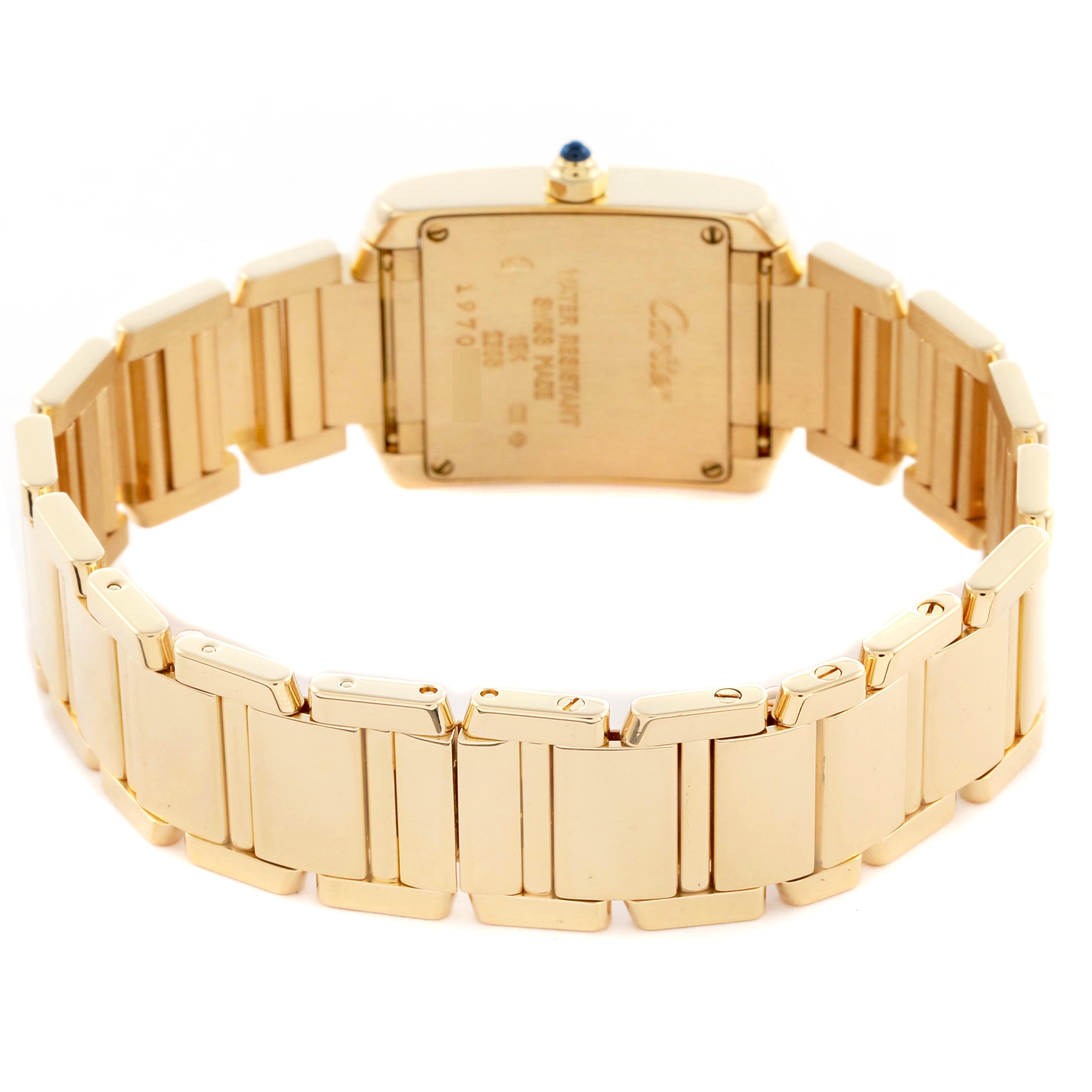 The Cartier Tank Francaise W50002N2 Women's Yellow Gold Silver Dial W50002N2 Women's Yellow Gold Silver Dial watch is shown from the back, highlighting the bracelet and case back.