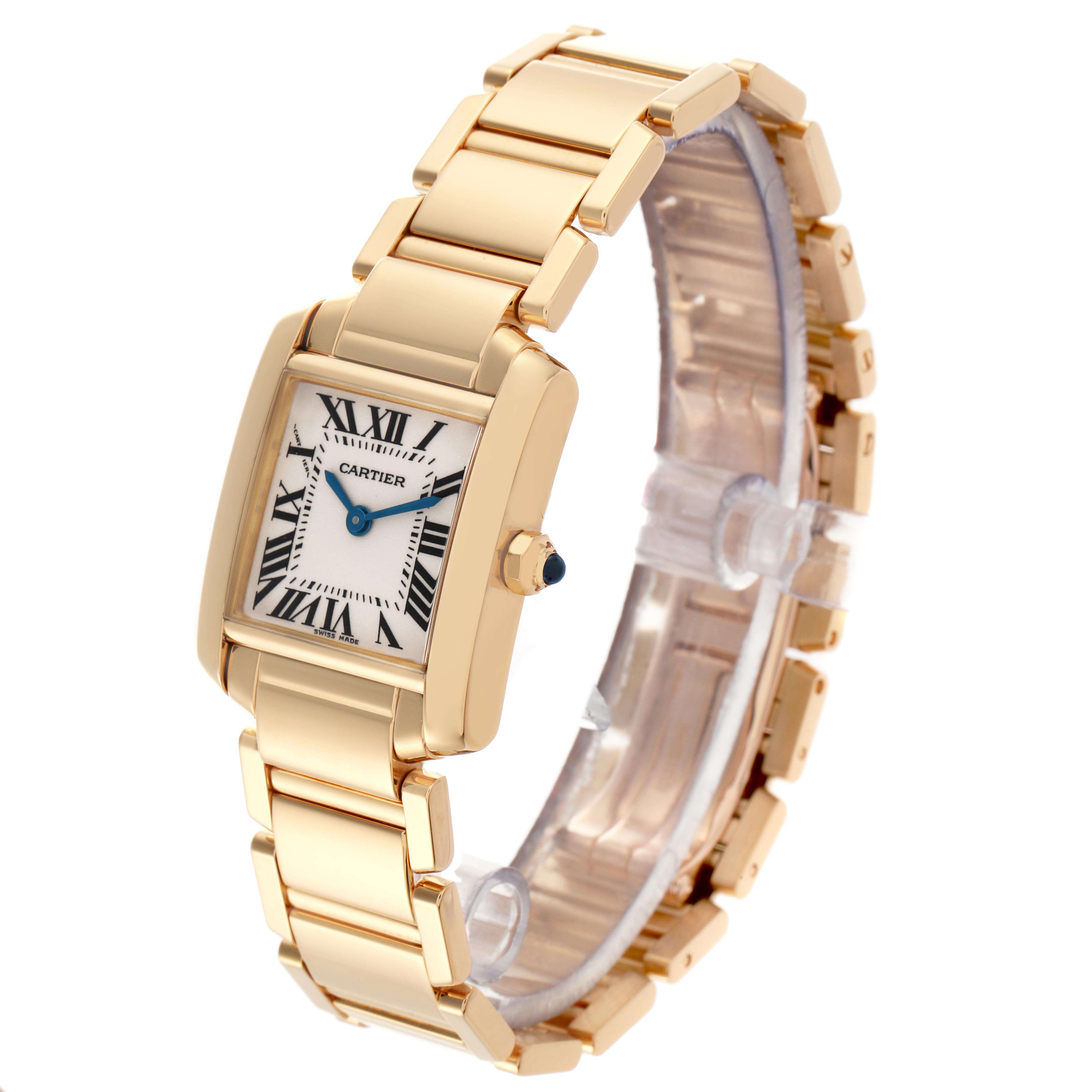 The Cartier Tank Française watch is shown at a slight angle, highlighting its gold case, bracelet, Roman numeral dial, and blue hands.
