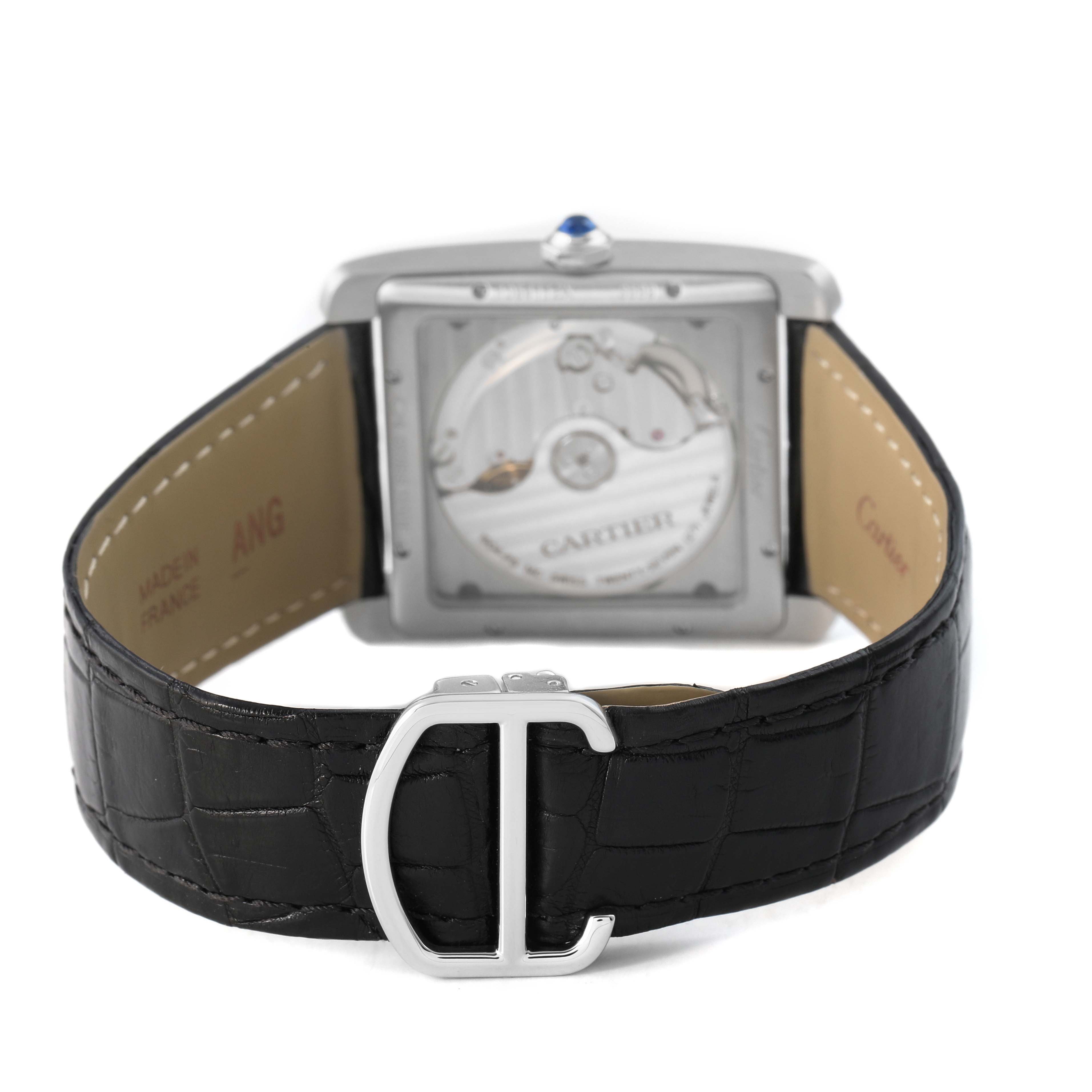 The image shows the back view of the Cartier Tank MC W5330003 Men's Stainless Steel Silver Dial watch, highlighting its movement, black leather strap, and "C" buckle.