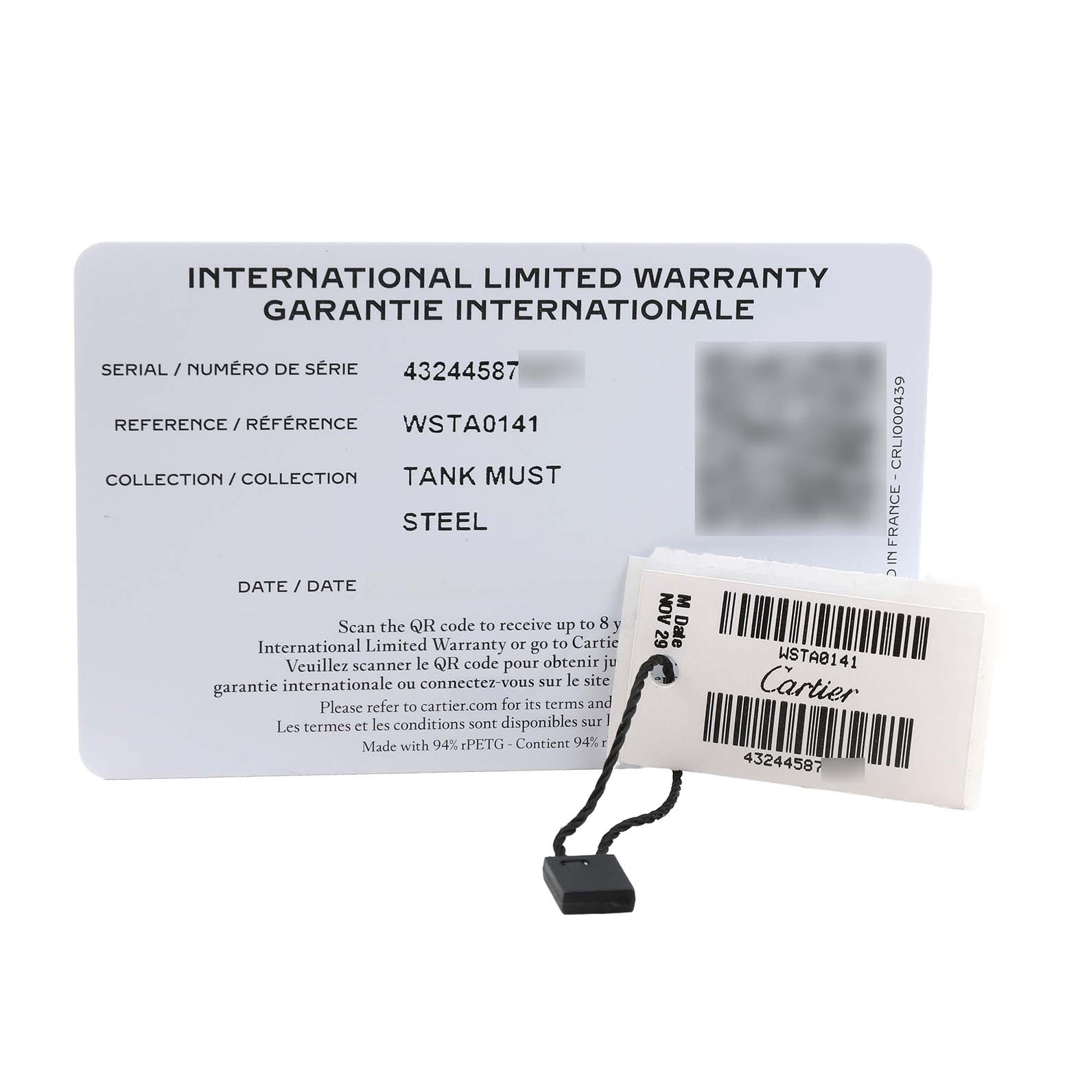 The image shows the international warranty card and tag for the Cartier Tank Must WSTA0141 Men's Stainless Steel Silver Dial model.