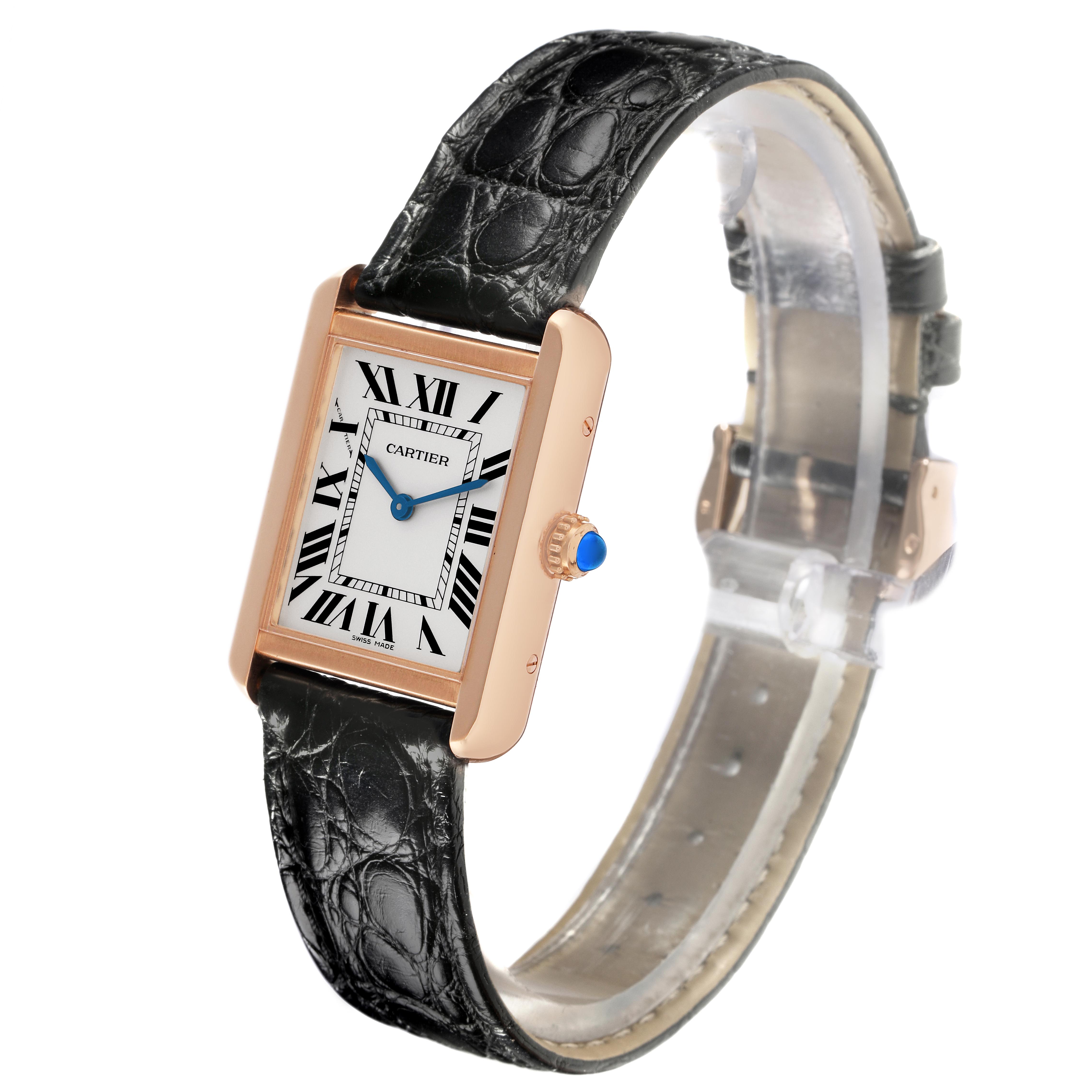 The Tank Solo by Cartier is shown at a slight angle, displaying the face, bezel, strap, and crown with a blue cabochon.