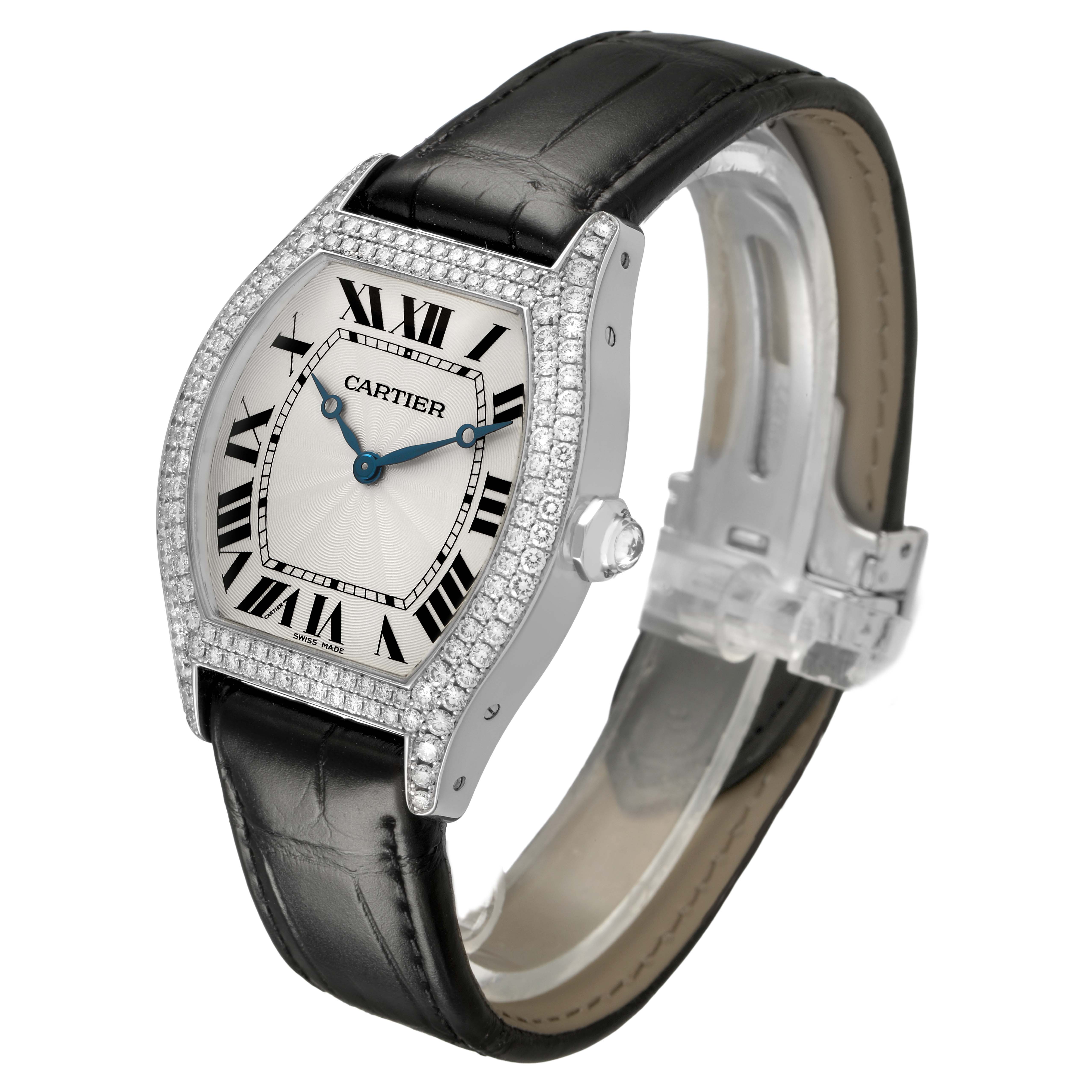 The Cartier Tortue WA503851 Men's White Gold Silver Dial watch is angled to show the face, bejeweled bezel, crown, and part of the leather strap.