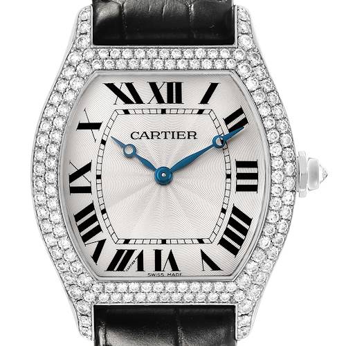 The Cartier Tortue WA503851 Men's White Gold Silver Dial watch is shown from a front angle, displaying its dial, blue hands, Roman numerals, diamond bezel, and black strap.