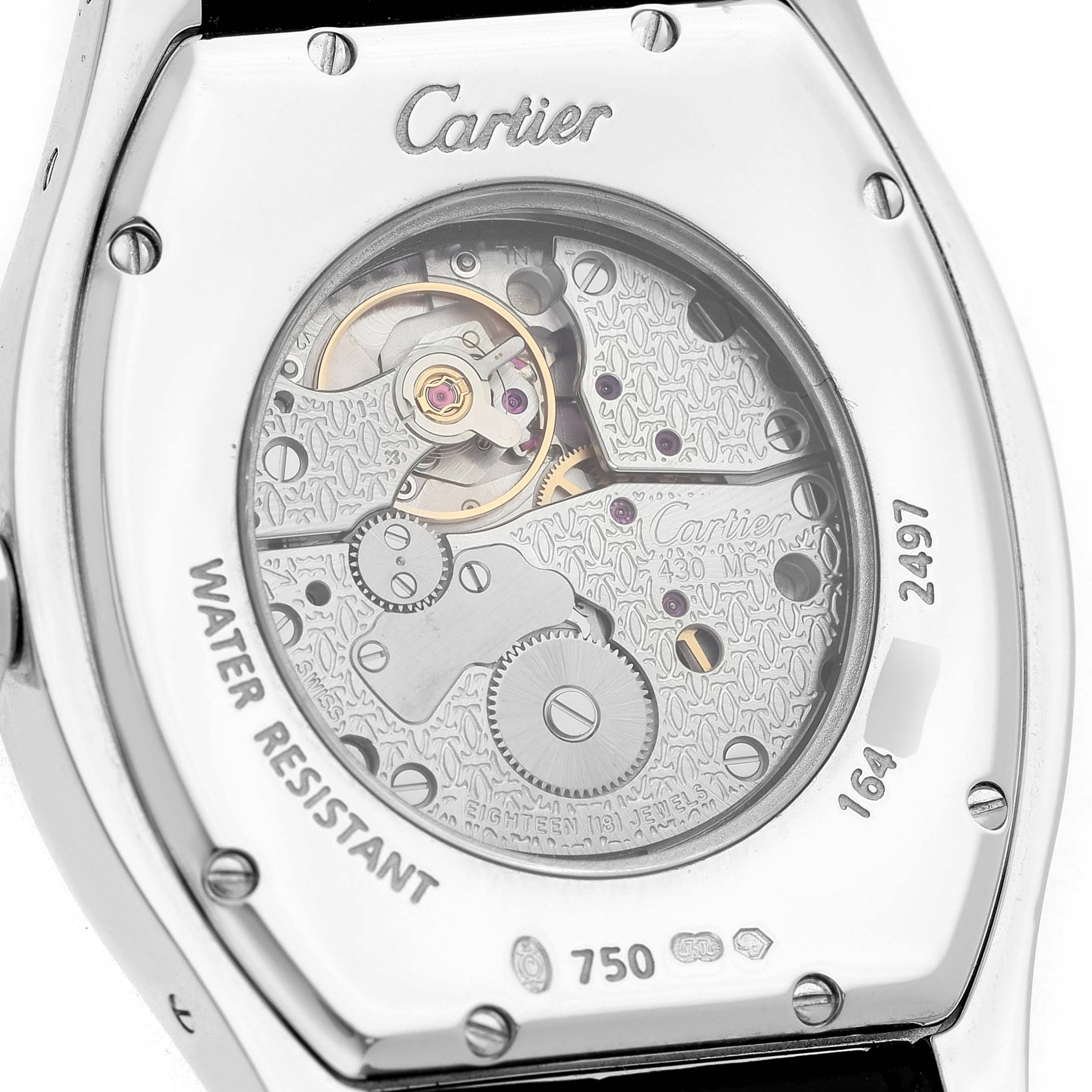 The image shows the back of the Cartier Tortue WA503851 Men's White Gold Silver Dial watch, highlighting its intricate movement and engraved details.