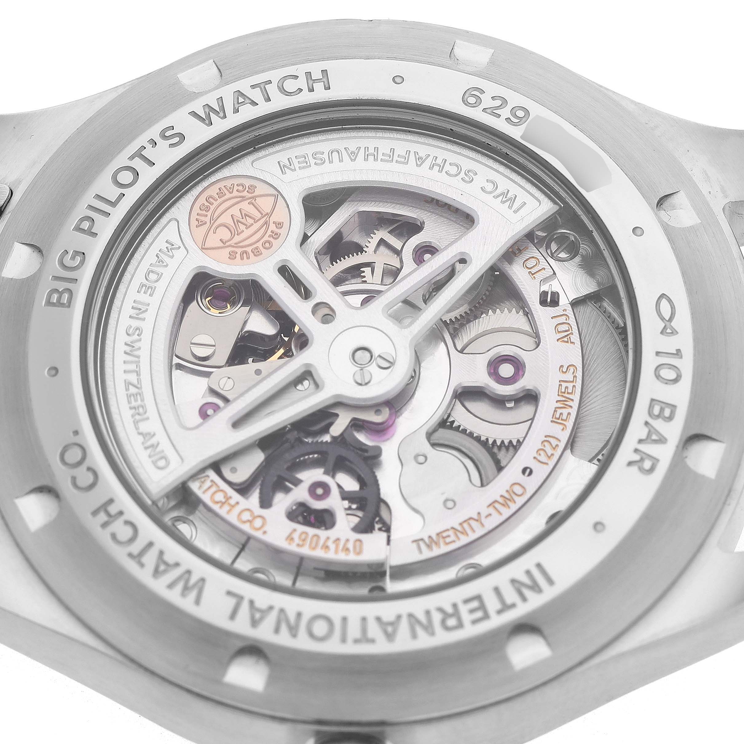 The image shows the open back view of an IWC Big Pilot’s Watch, highlighting its intricate inner mechanisms and engraved details.