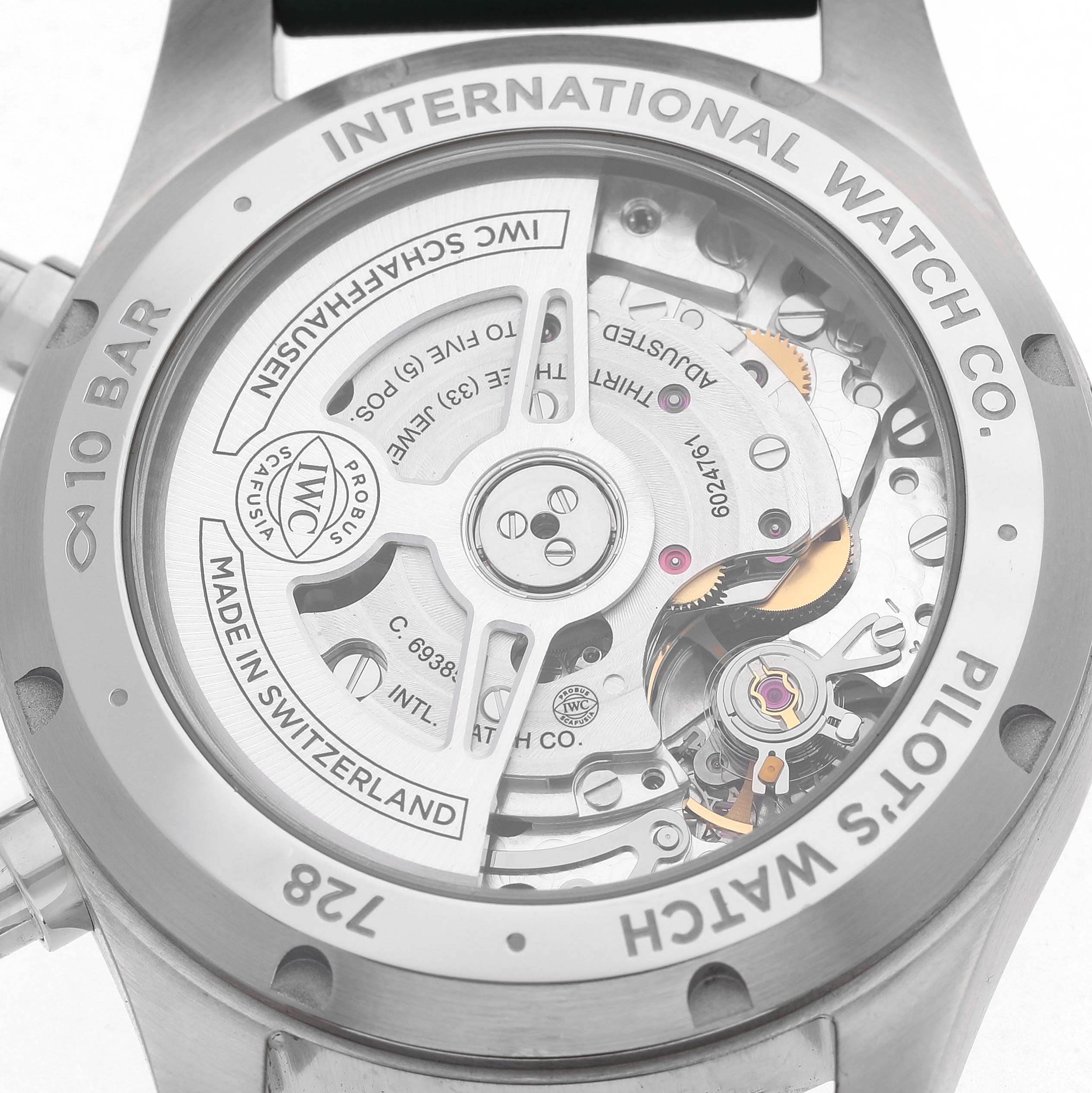 The image shows the back of an IWC Pilot IW388103 Men's Stainless Steel Green Dial model watch, highlighting the internal movement and branding details.