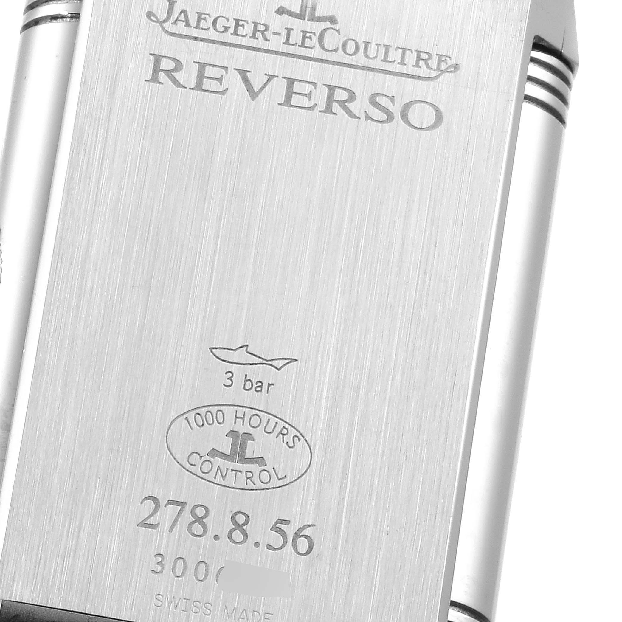 The image shows the back casing of a Jaeger-LeCoultre Reverso watch, displaying its engravings and specifications.