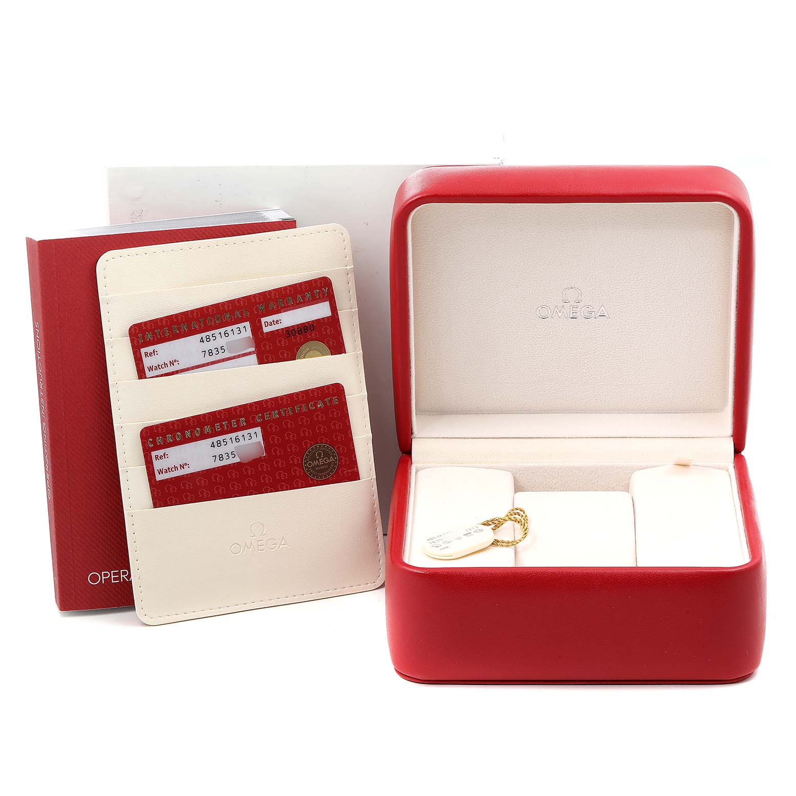 The image shows the packaging of an Omega De Ville 4851.61.31 Men's Stainless Steel Red Dial 4851.61.31 Men's Stainless Steel Red Dial watch, including warranty cards, a red watch box, and tags.