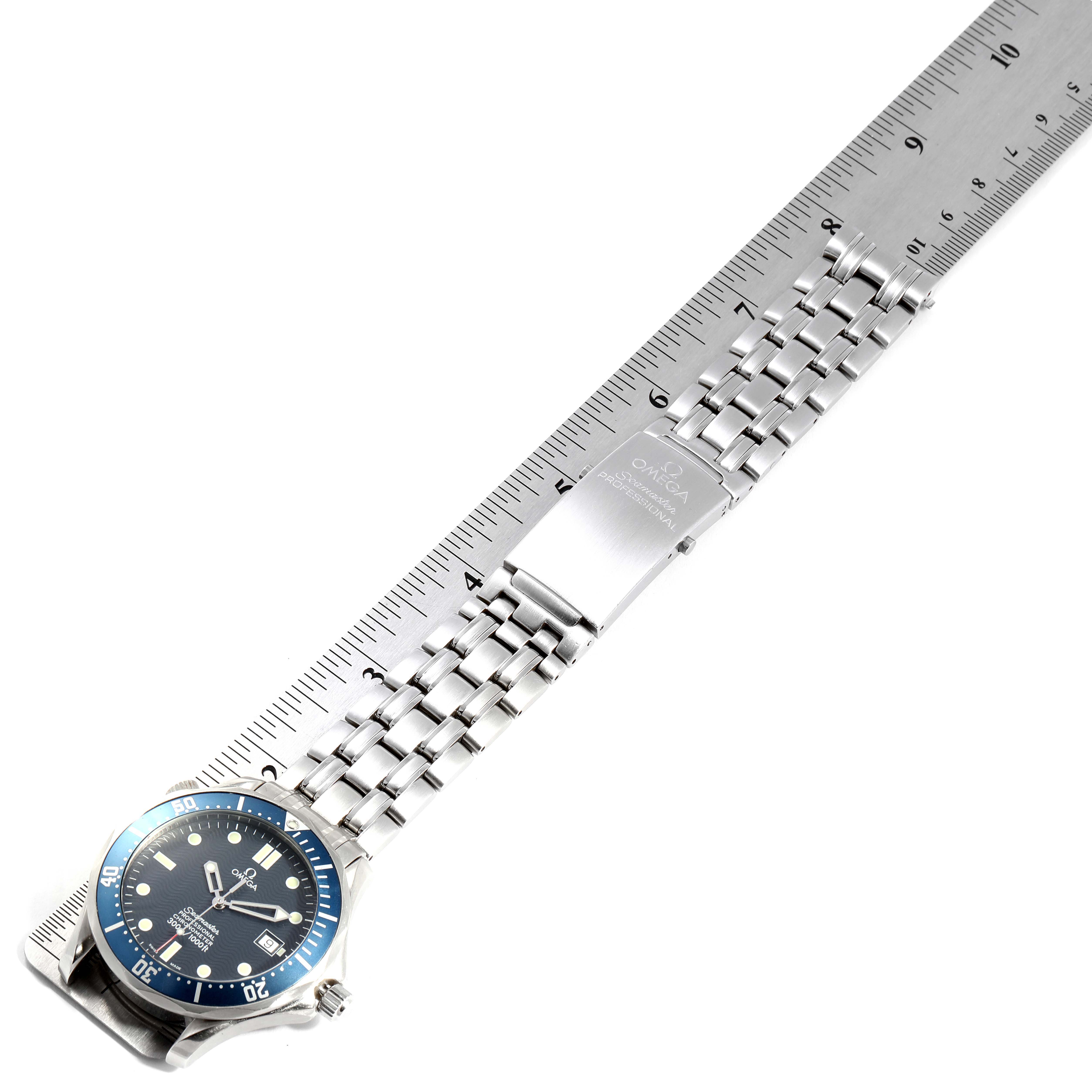 The image shows an Omega Seamaster 2531.80.00 Men
s Stainless Steel Blue Dial 2531.80.00 Men
s Stainless Steel Blue Dial watch laid flat, displaying its face, bracelet, and clasp, next to a ruler for scale.