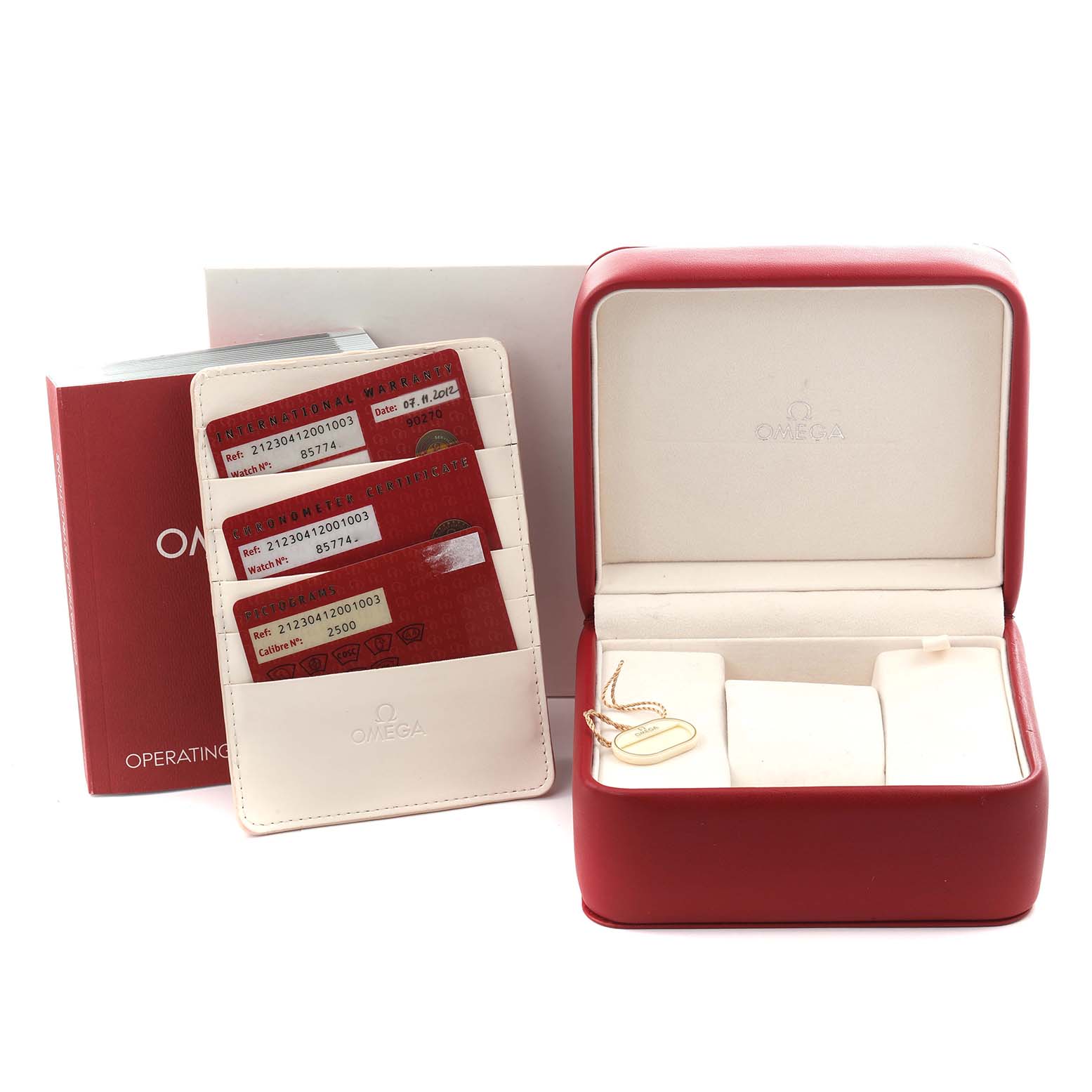 The image shows a red Omega watch box, operating manual, and warranty cards for a Seamaster model.