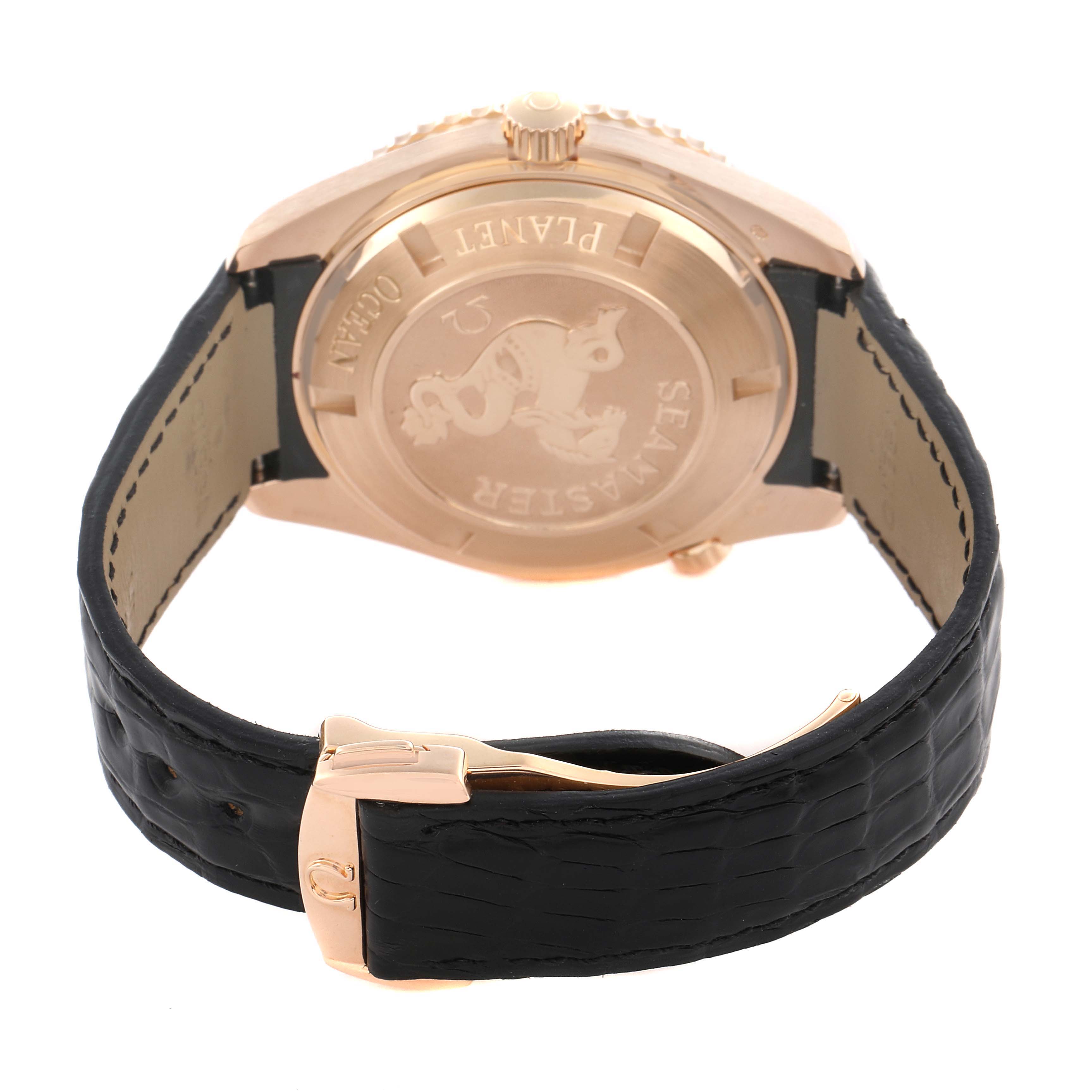 The image shows the back view of the Omega Planet Ocean 222.63.46.20.01.001 Men's Rose Gold Black Dial 222.63.46.20.01.001 Men's Rose Gold Black Dial watch, highlighting the case back and leather strap with a clasp.