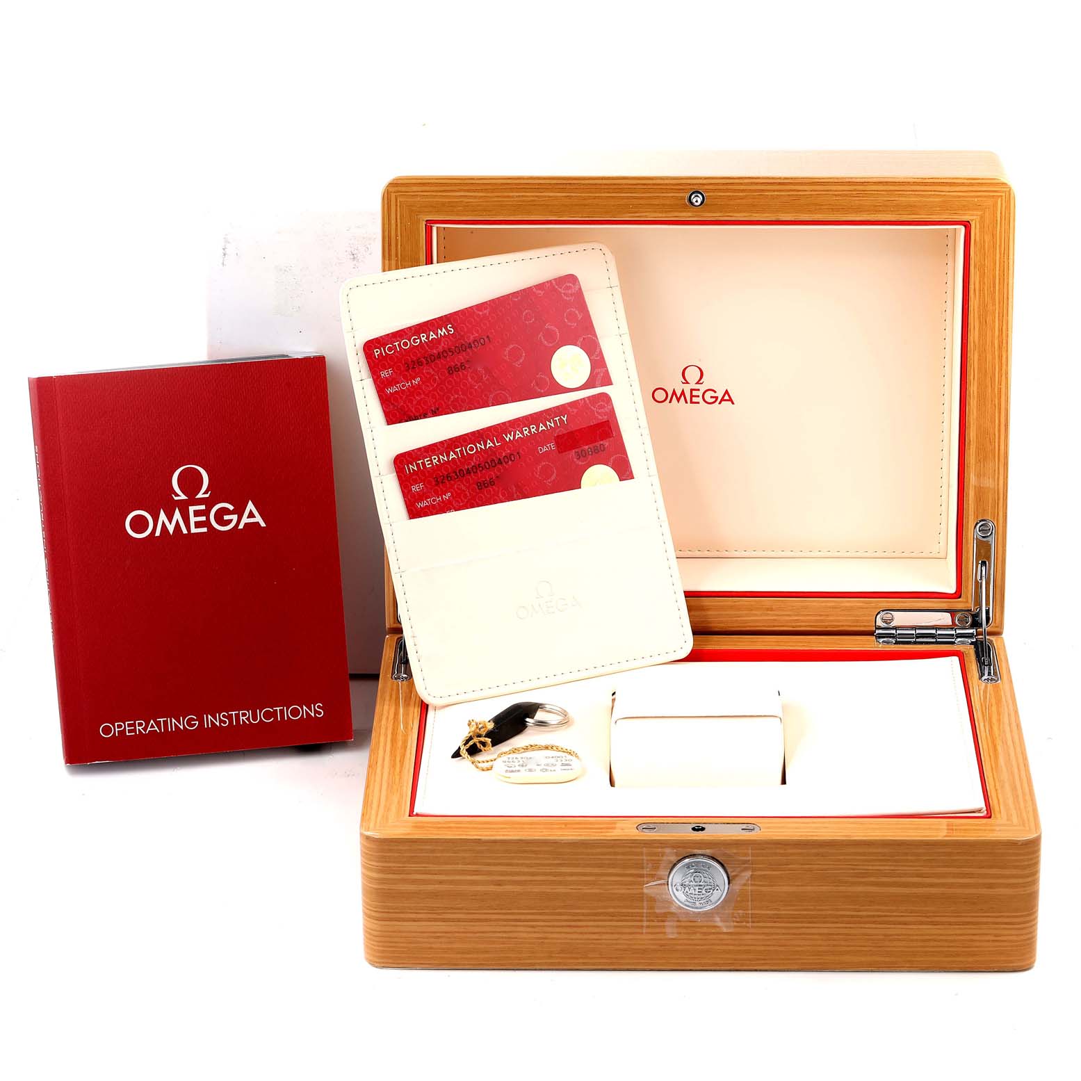 The image shows an Omega Speedmaster 326.30.40.50.04.001 Men's Stainless Steel White Dial 326.30.40.50.04.001 Men's Stainless Steel White Dial watch box with operating instructions, a warranty card holder, and a watch tag.