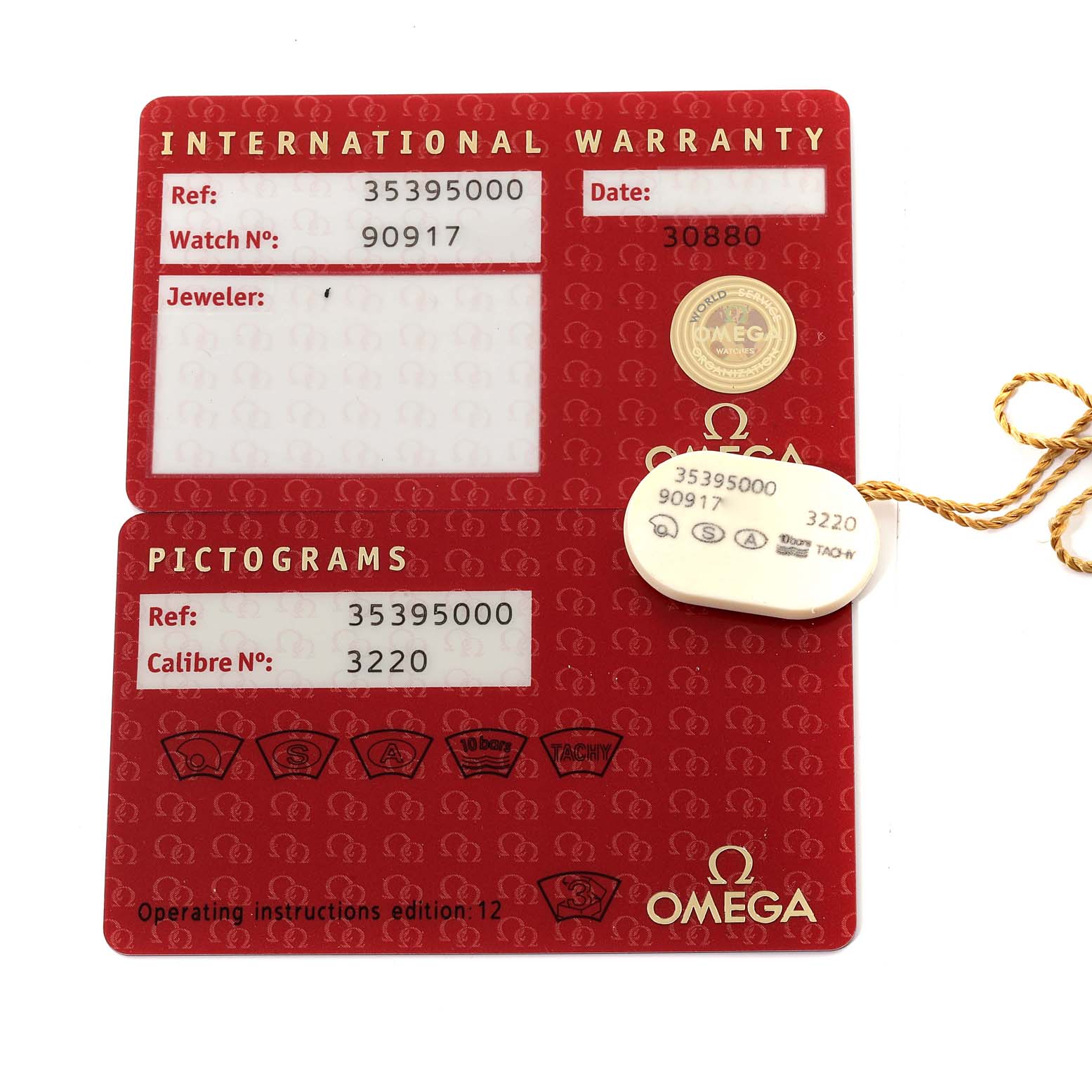 The image shows the international warranty card and pictograms card for the Omega Speedmaster 3539.50.00 Men
s Stainless Steel Black Dial 3539.50.00 Men
s Stainless Steel Black Dial model with associated tags.