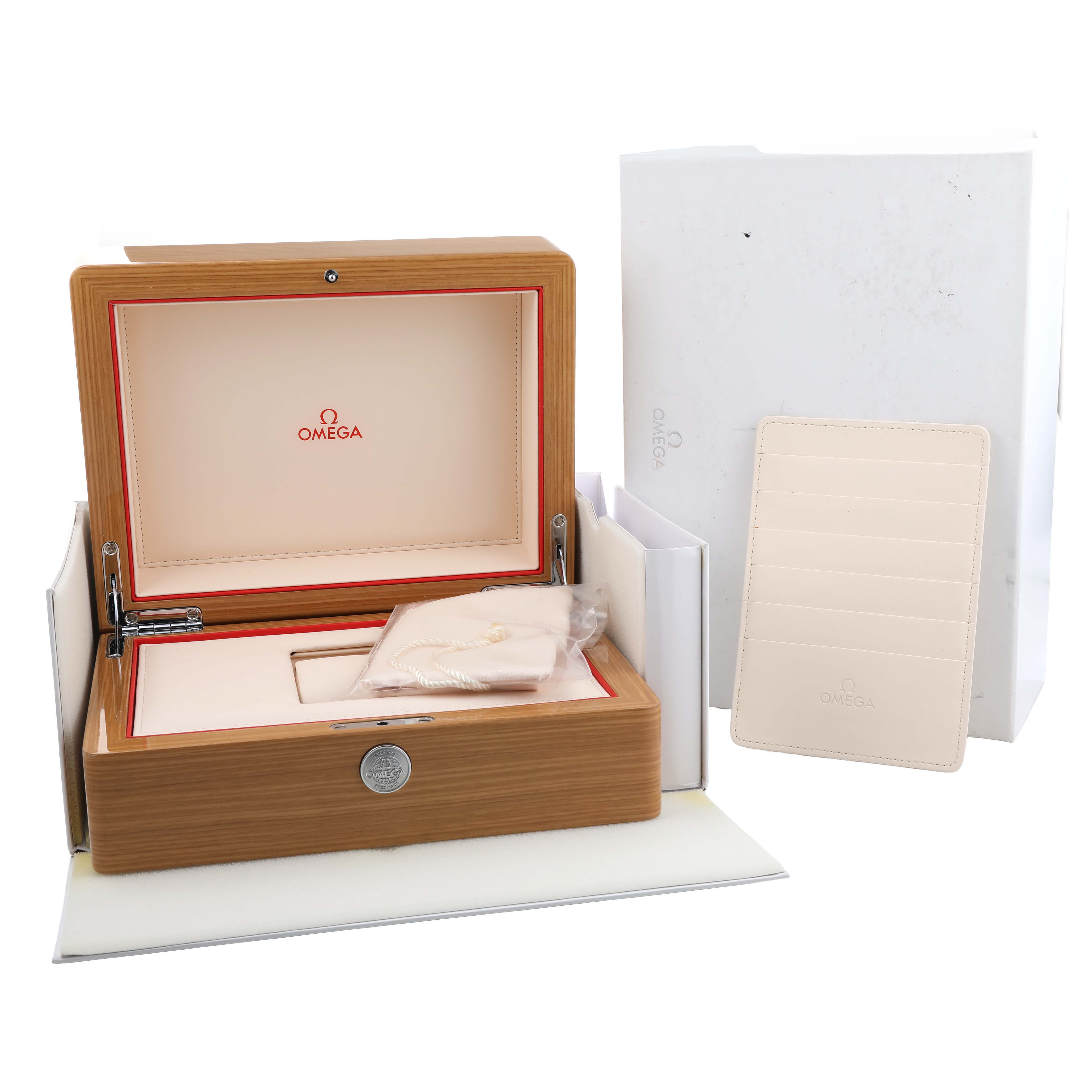 The image shows the Omega Speedmaster 522.30.42.30.06.002 Men's Stainless Steel Silver Dial's packaging, including the open wooden box, outer box, and cardholder.
