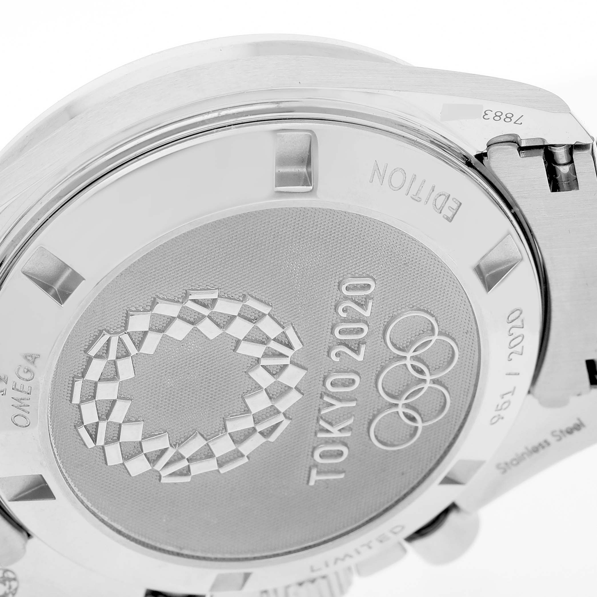 The image shows the case back of an Omega Speedmaster 522.30.42.30.06.002 Men's Stainless Steel Silver Dial, featuring the Tokyo 2020 Olympics engraving.